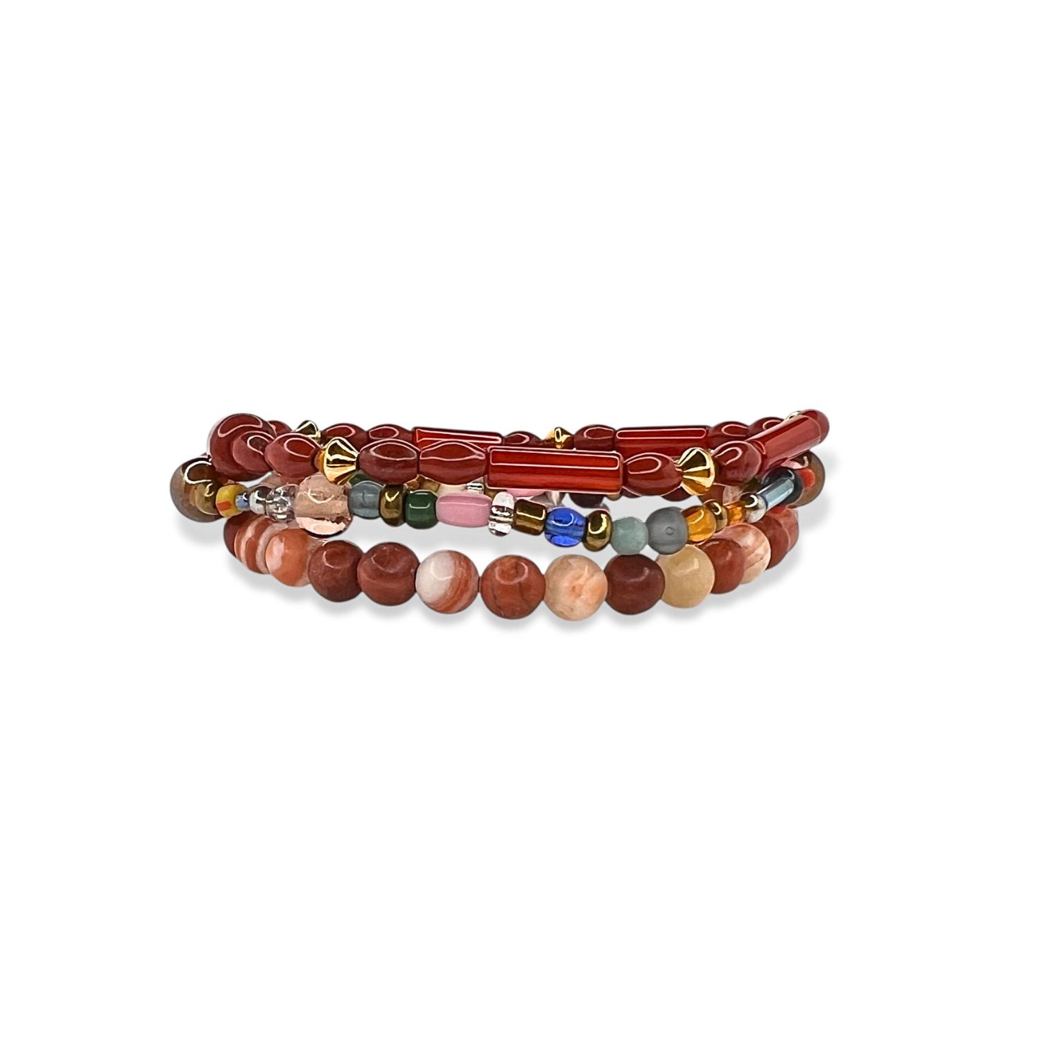 The Scorpion King Bracelet Set by JAREDJAMIN Jewelry Online features a jasper bead bracelet with reddish-brown and beige stones, paired with a mixed bead strand in gold, green, blue, dark tones, and brick red accents on a white background.
