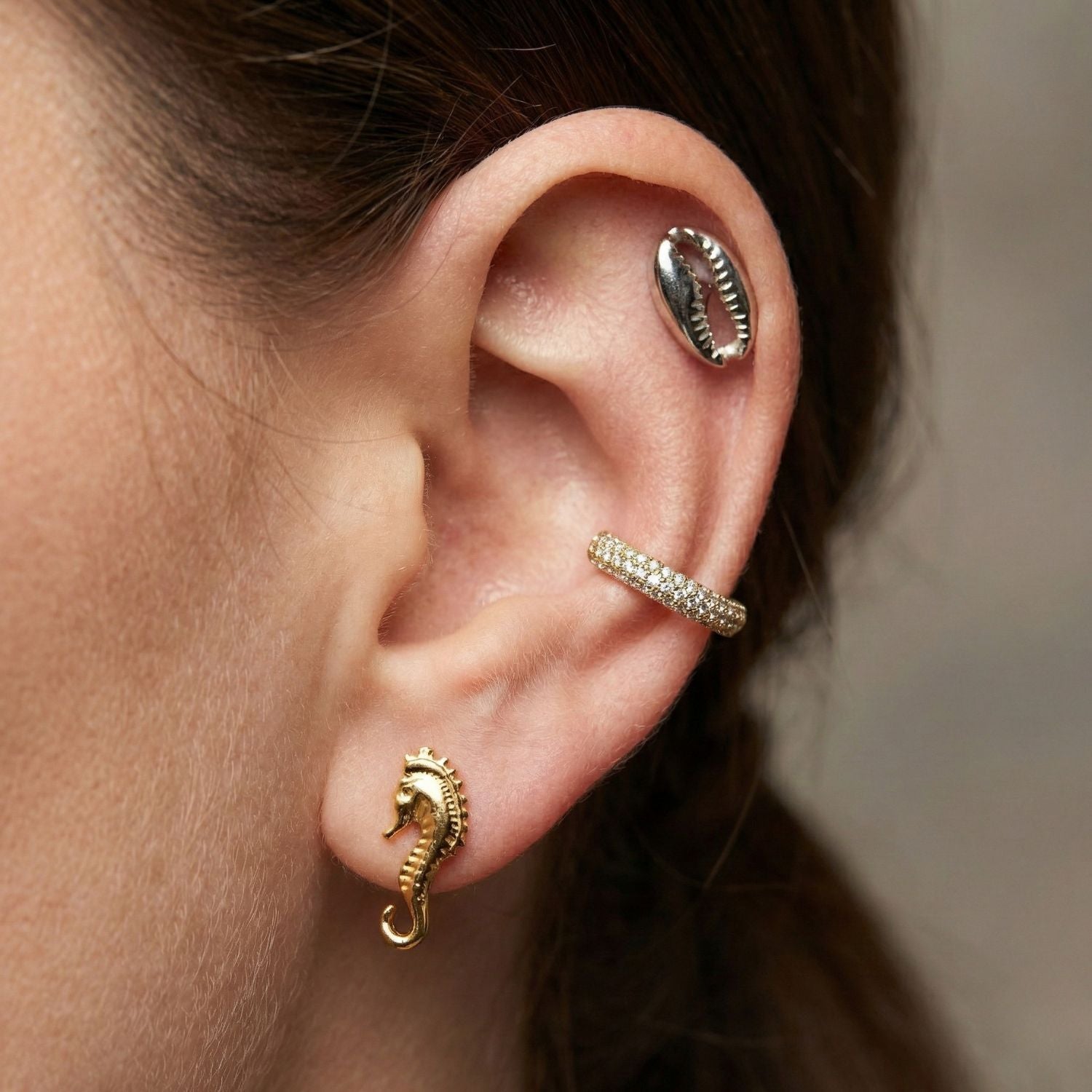 The Sea Scooter Post Earrings by JAREDJAMIN Jewelry Online are small, silver-plated seahorse studs with detailed, textured bodies and curled tails, shown facing each other on a plain white background.