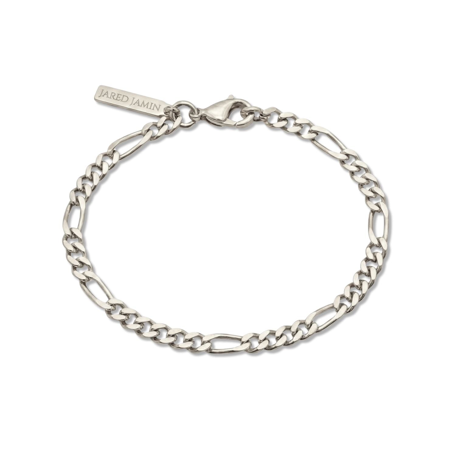 The Silver Finley-Figaro Chain Bracelet by JAREDJAMIN Jewelry Online features alternating flat and oval links, a secure lobster clasp, and a branded tag, elegantly displayed on a white background.
