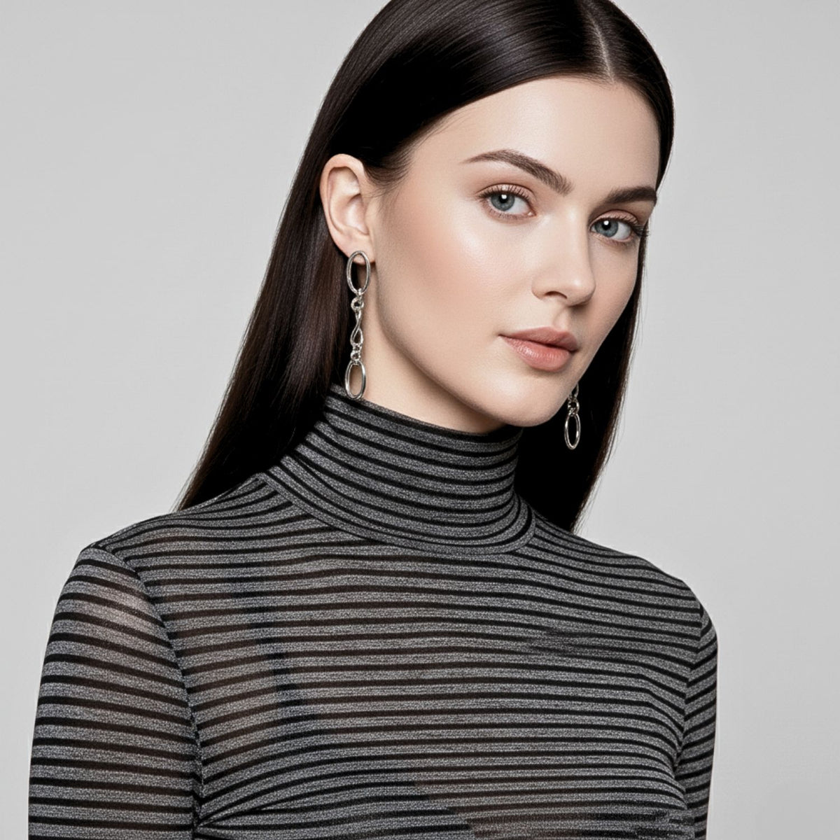 Un woman con long hair en un striped shirt wears JAREDJAMIN Joyería Online’s plata Ophelia cadena Dangle Post pendientes.