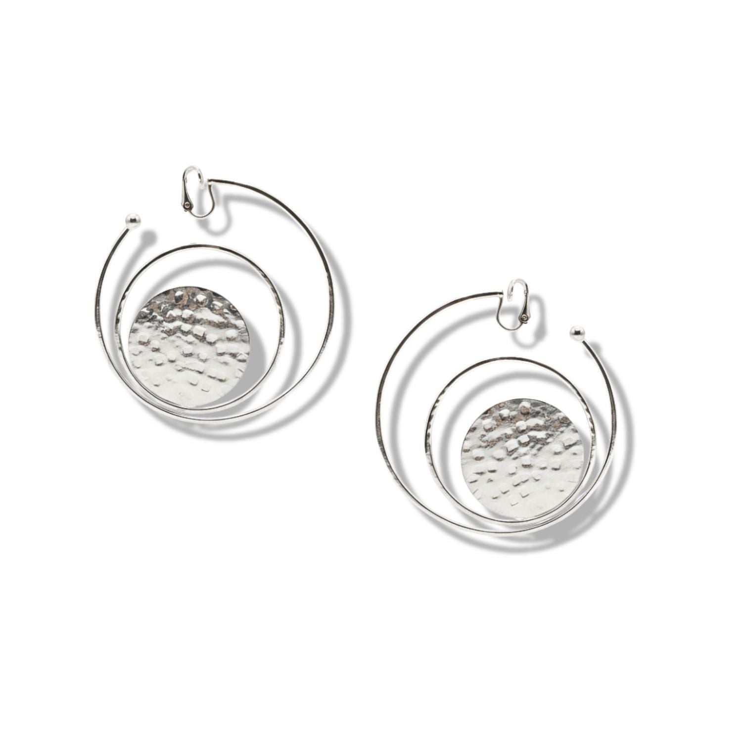 The Silver Peacock Clip On Hoop Earrings by JAREDJAMIN Jewelry Online feature large hammered discs encircled by smooth wire hoops, creating an abstract, geometric look perfect for modern style.