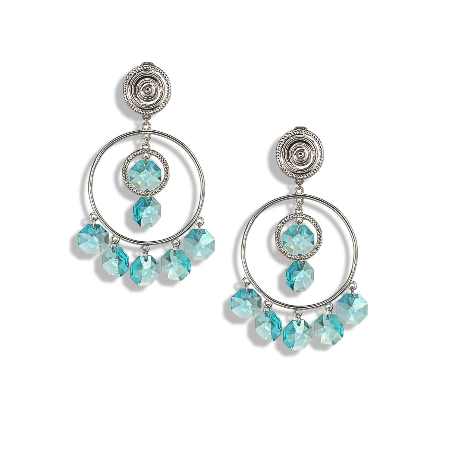 The Starshine Chandelier Clip On Earrings by JAREDJAMIN Jewelry Online feature silver hoops with round studs, a central blue faceted bead, and five Swarovski crystals dangling below for a sparkling chandelier look.