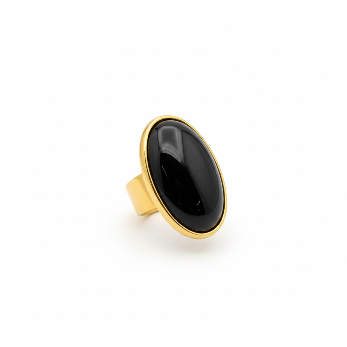 The Stella Statement Ring in Black Agate by JAREDJAMIN Jewelry Online features a large, polished oval stone in an 18K gold-plated bezel with a wide, adjustable band, shown against a plain white background.