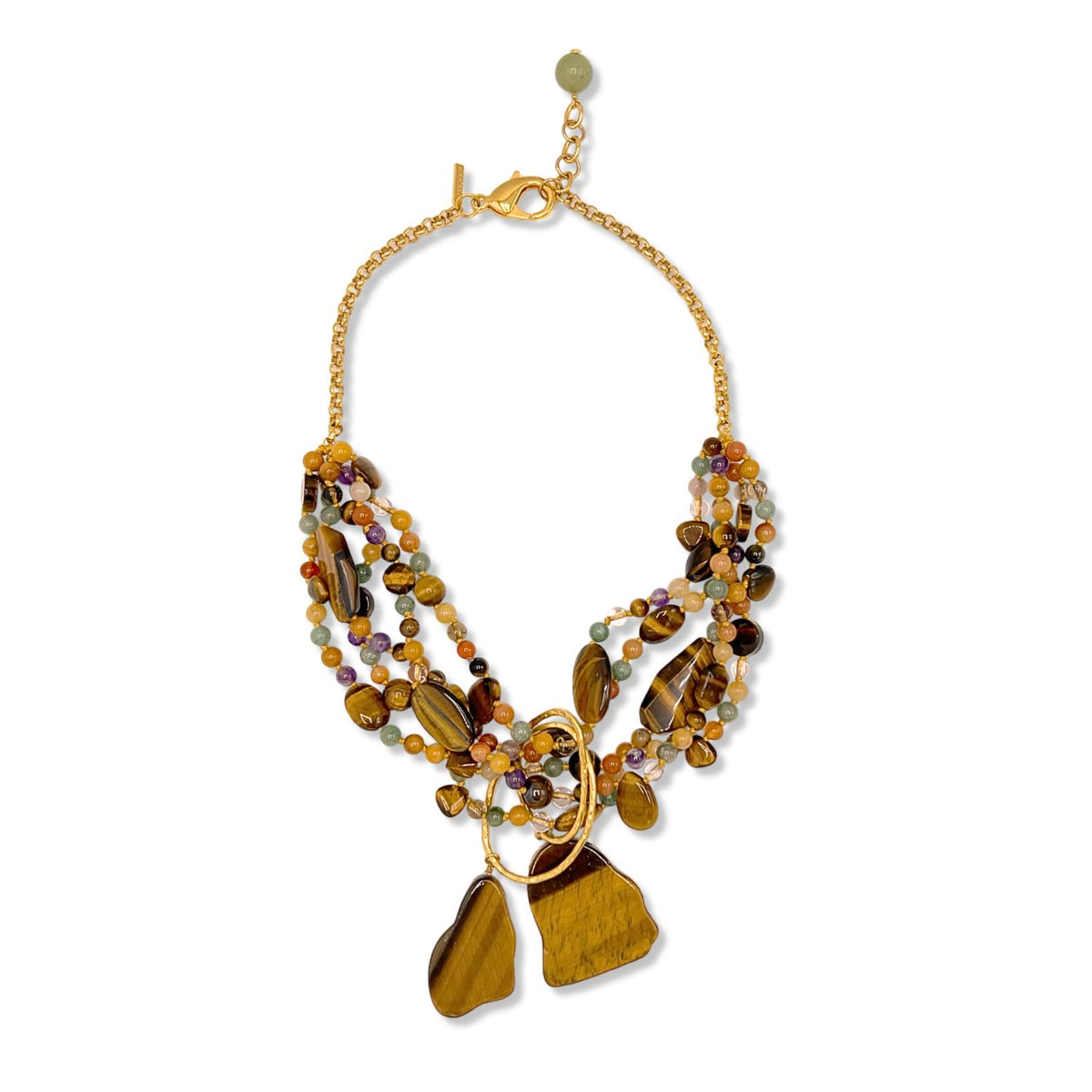 The Sybil Tiger’s Eye Gemstone Necklace from JAREDJAMIN Jewelry Online features gold chains, layered brown, yellow, and purple beads, large tiger’s eye gemstones, and gold loops for a striking artisanal look.