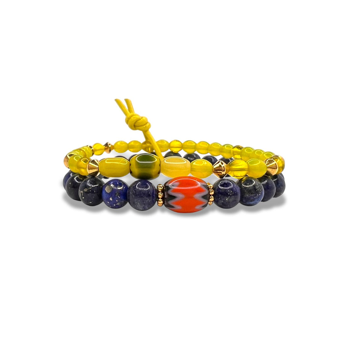 The Trail Blazer Bracelet Set by JAREDJAMIN Jewelry Online features alternating yellow, gold, blue, and green beads with a large oval red bead with a white zigzag as the centerpiece for a stylish layered look.