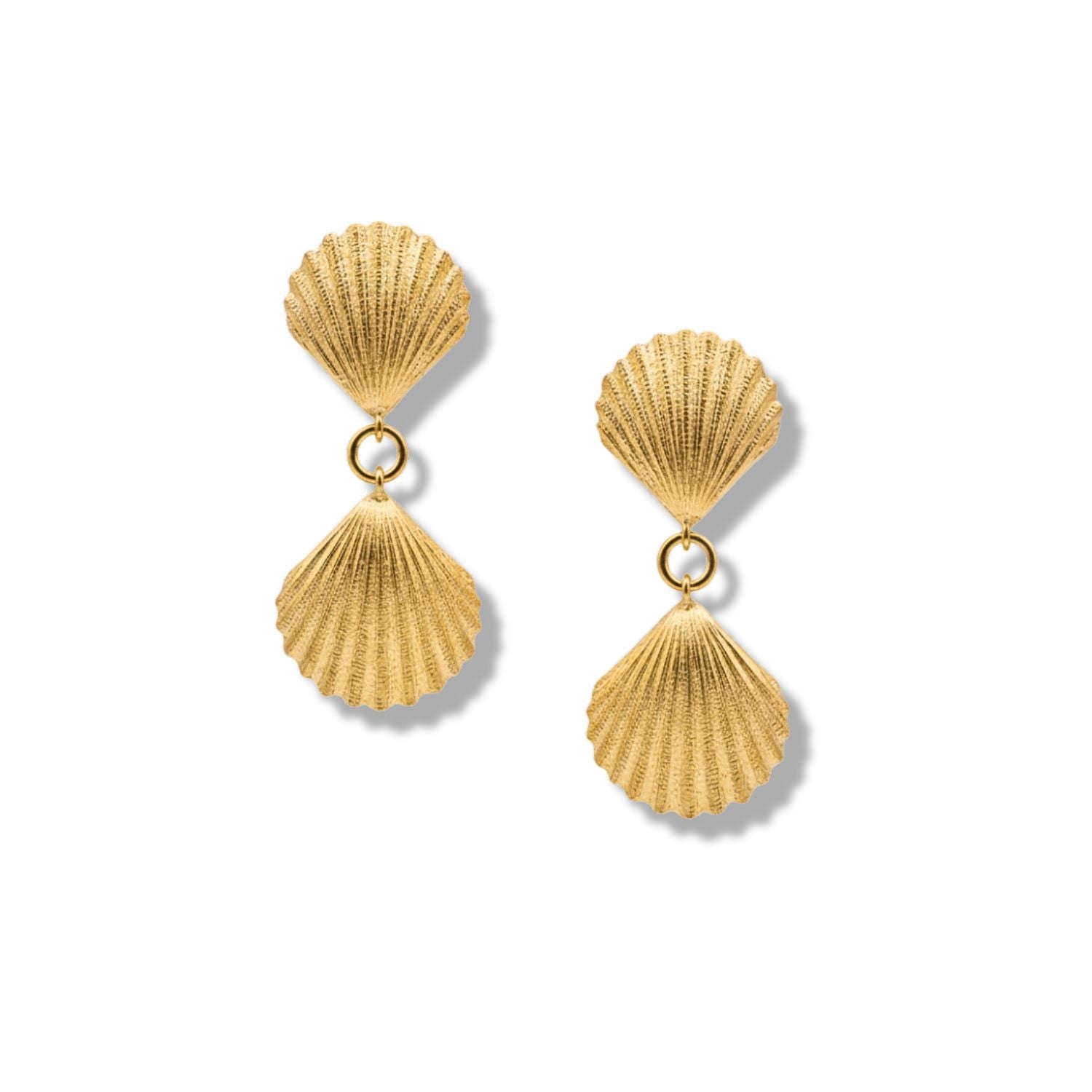 The Gold Venus Clip On Earrings by JAREDJAMIN Jewelry Online feature two textured, gold scallop shells connected by a small ring for a dangle effect—perfect resort-ready shell-inspired jewelry.