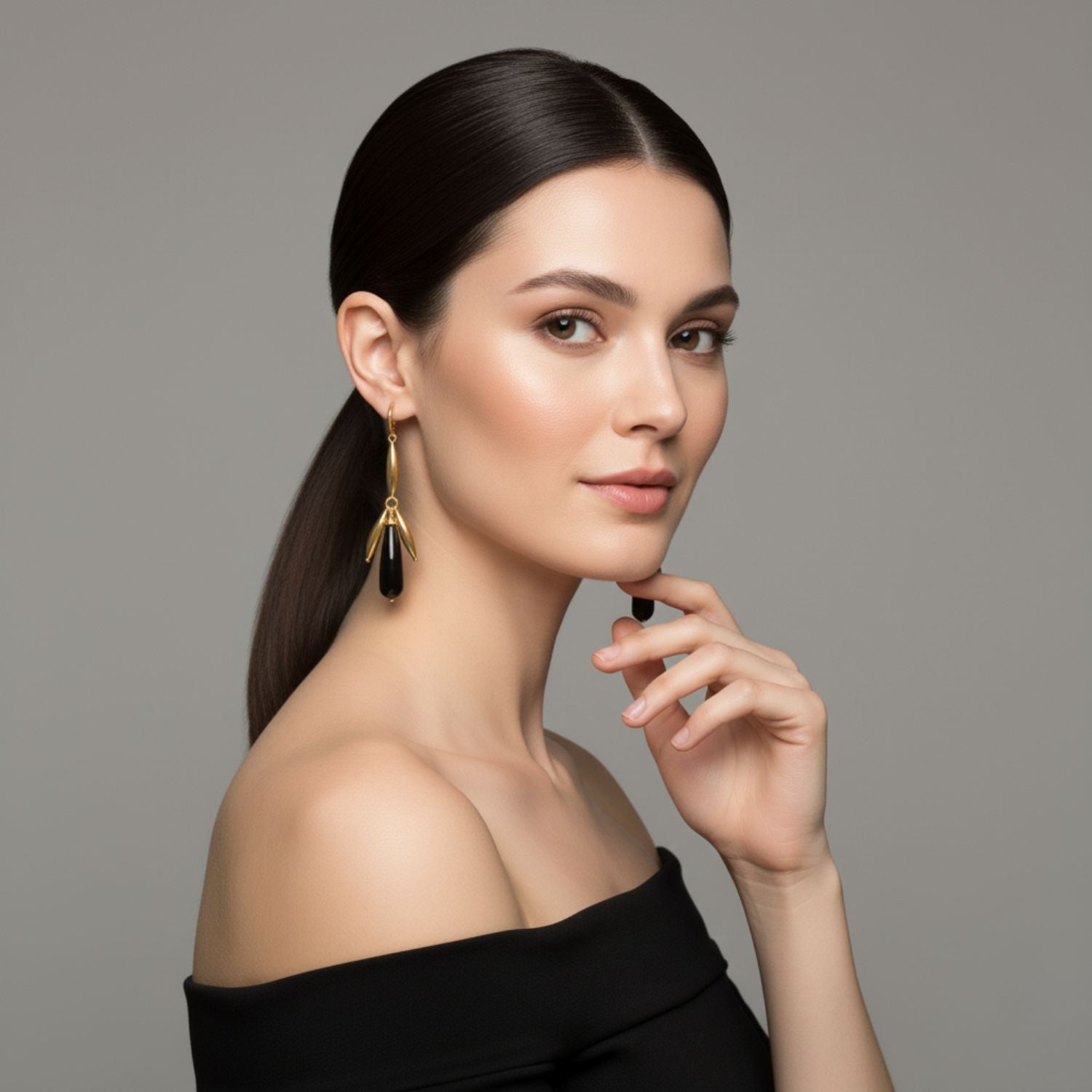 The Wisteria Dangle Leverback Earrings by JAREDJAMIN Jewelry Online feature gold-toned elongated oval links and teardrop black pendants in a symmetrical, elegant design with secure leverback closures against a plain white background.