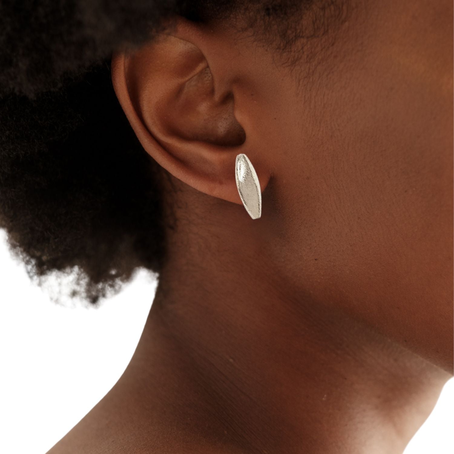 The Silver Zeppelin Stud Post Earrings by JAREDJAMIN Jewelry Online feature elongated, textured oval studs on simple post backings, shown against a plain white background with soft shadows.