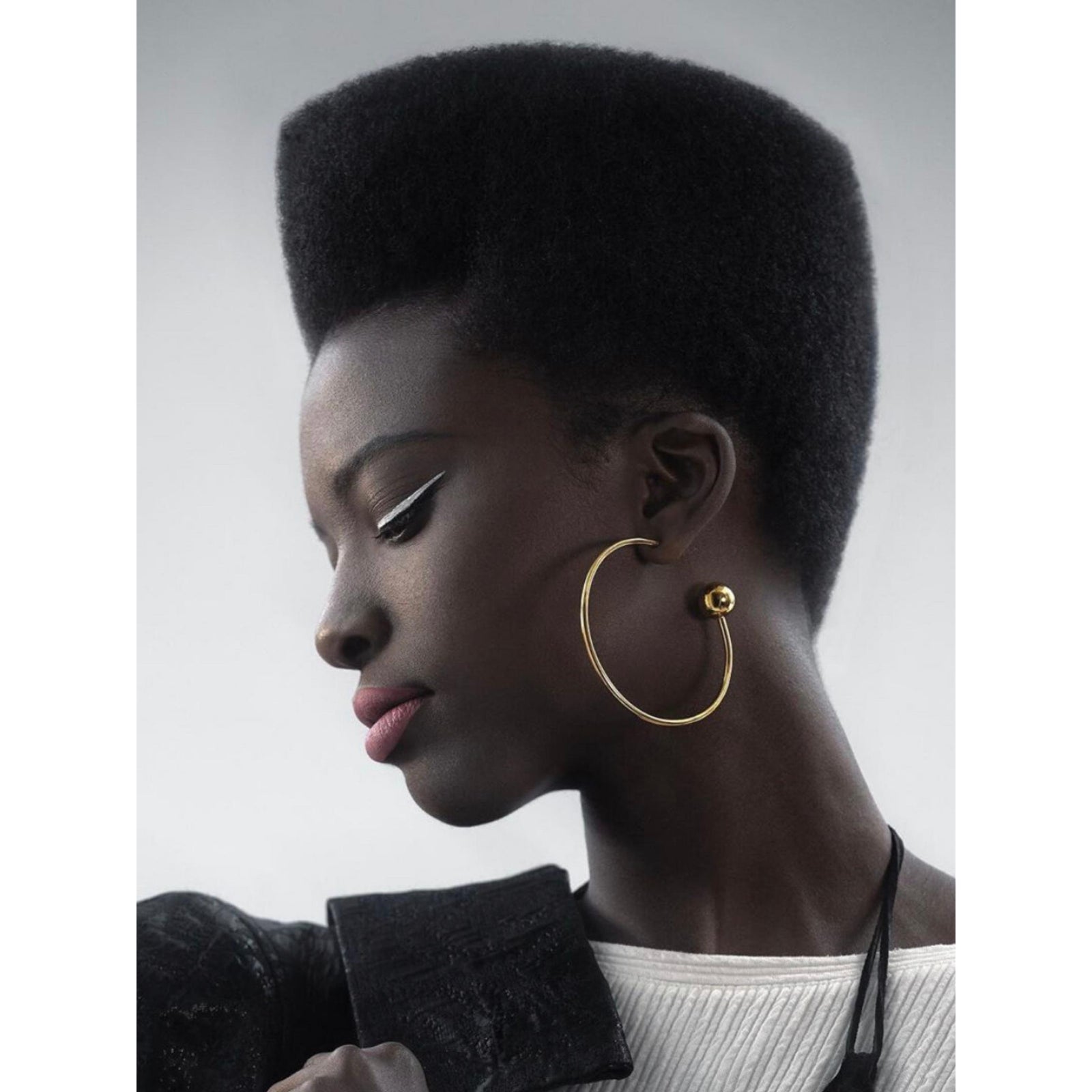 The Gold Orbita Comet Earrings by JAREDJAMIN Jewelry Online are 18K gold hoops with a minimalist design, each featuring a thin circular hoop and a polished gold sphere at the end, displayed on a white background.