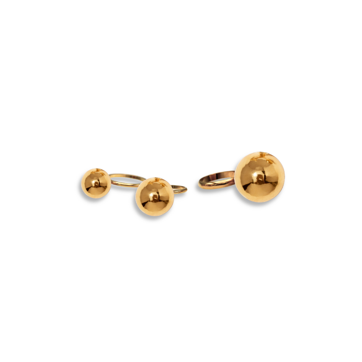 The Orbita Gold Three Ring Stack by JAREDJAMIN Jewelry Online, featuring shiny gold stackable rings with small and large sphere accents, displayed on a white background with soft shadows.