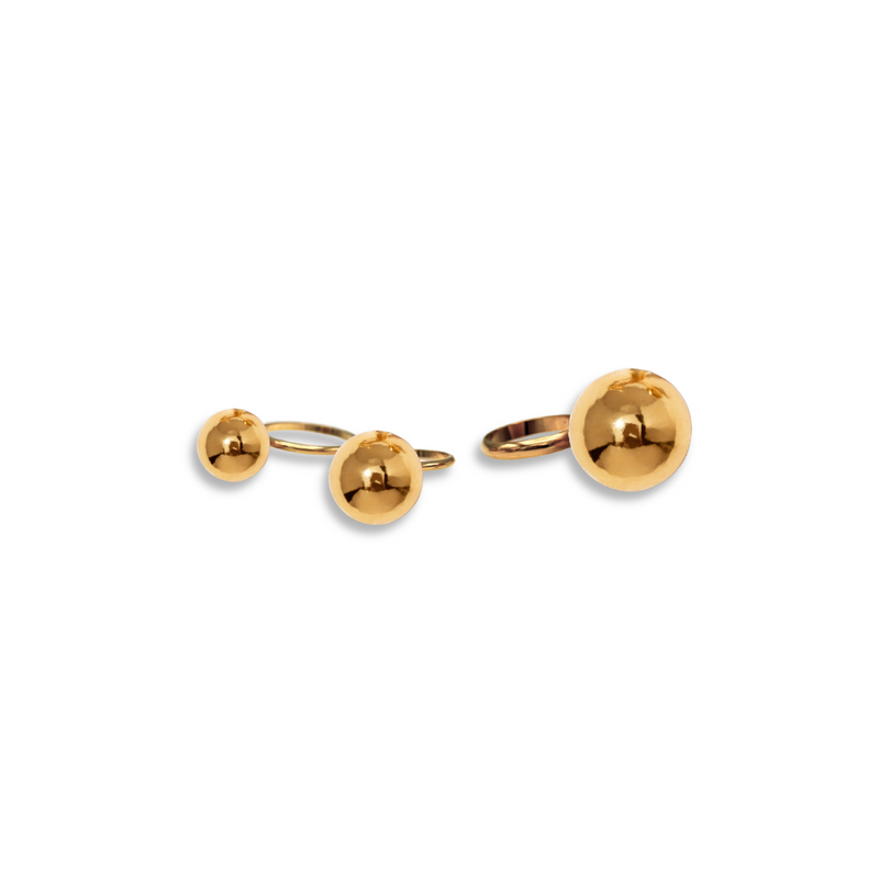 The Orbita Gold Three Ring Stack by JAREDJAMIN Jewelry Online, featuring shiny gold stackable rings with small and large sphere accents, displayed on a white background with soft shadows.