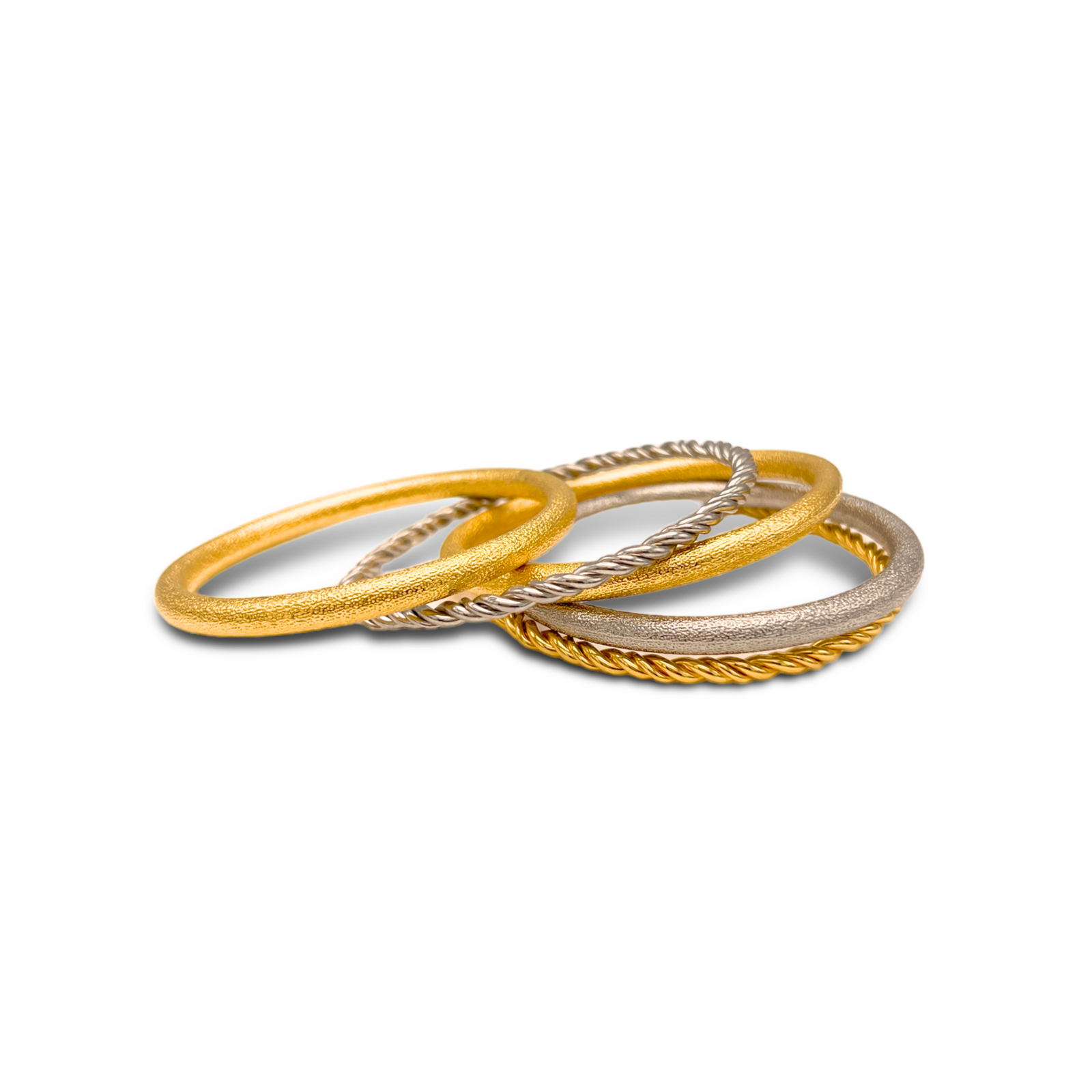 The Jubilee Silver and Gold Bangle Stack by JAREDJAMIN Jewelry Online features five textured bangles—two matte gold, one matte silver, plus a gold and a silver rope-style ring—arranged in alternating colors on a white background.