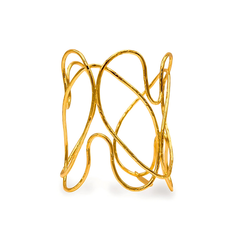 The Gold Fluttering Heart Cuff Bracelet by JAREDJAMIN Jewelry Online features an open 18K gold plate design with intersecting wavy lines, creating a modern, airy look with artistic flair and a shiny, reflective surface.