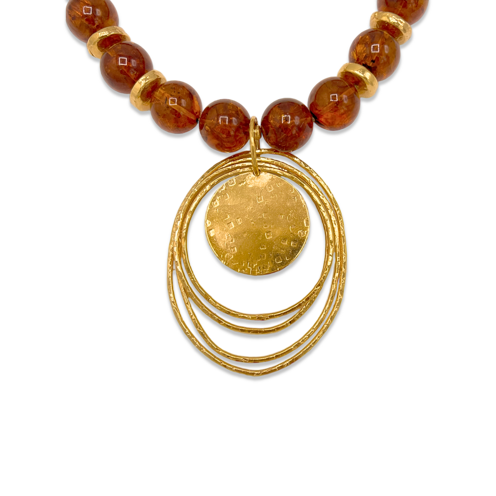 The Peacock Dawn Pendant Amber Necklace by JAREDJAMIN Jewelry Online features large round amber beads, small gold rings, a textured 18k gold-plated disc layered with three hoops, and an adjustable clasp with chain closure.