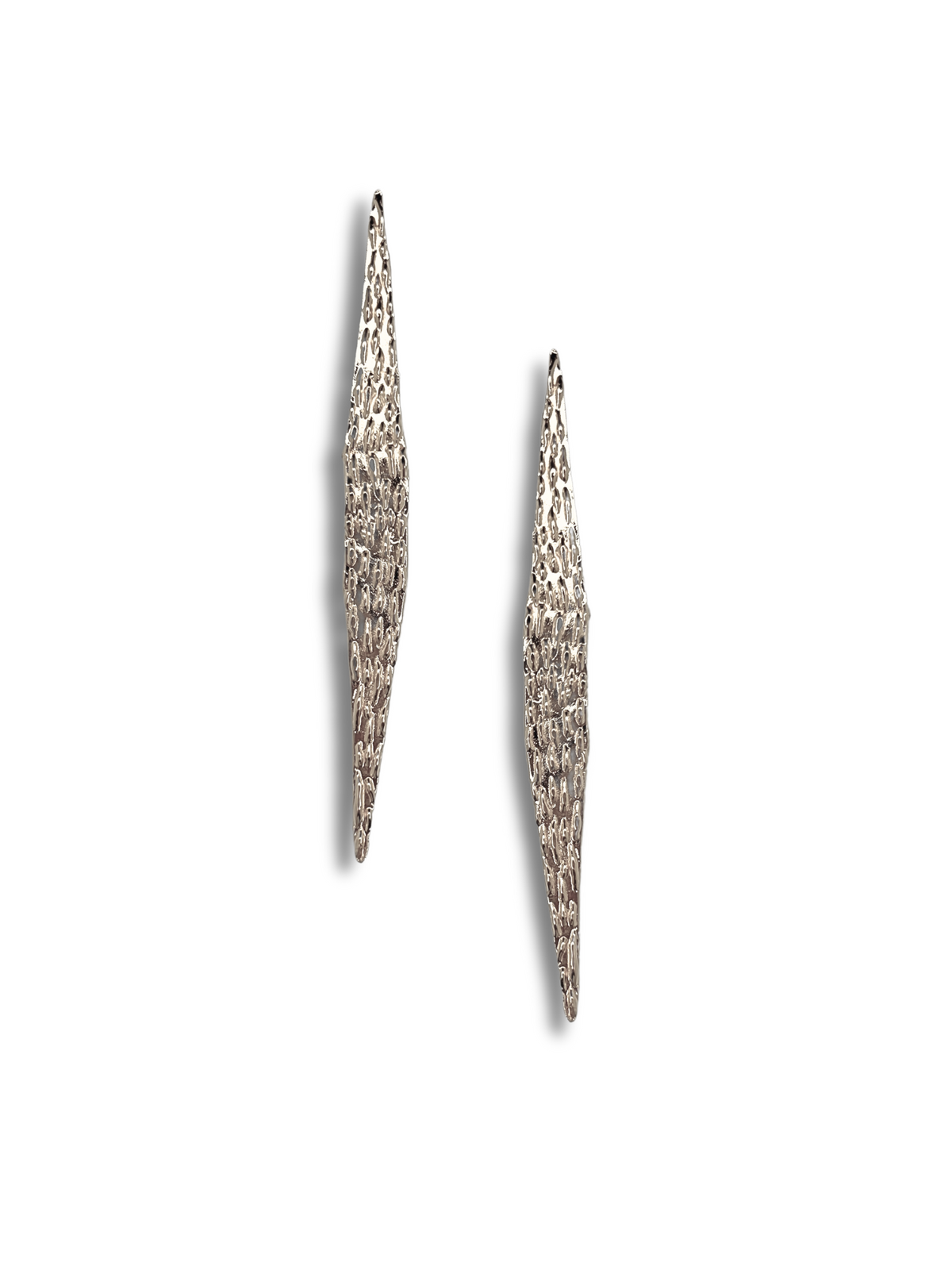 The Jaguaretê Earrings by JAREDJAMIN Jewelry Online are silver, textured drop earrings shown vertically on a white background. Their elongated abstract design features intricate details for a shimmering look, casting subtle shadows that enhance the image&#39;s depth and dimension.