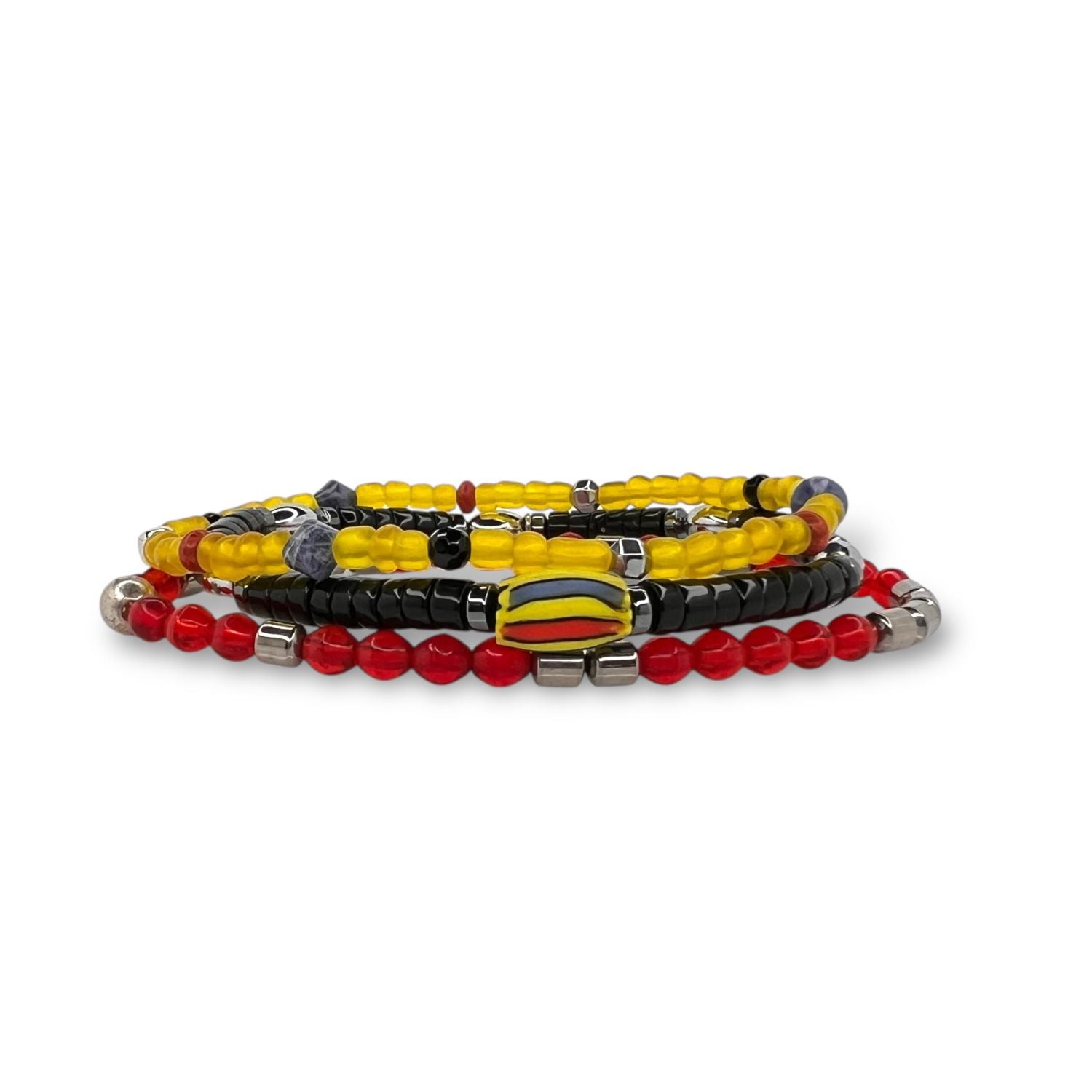 The Samurai Bracelet Set by JAREDJAMIN Jewelry Online includes four stretch bracelets in red, yellow, black, silver, and dark purple with round and cylindrical beads. Some beads are metallic, creating a bold, colorful layered look.