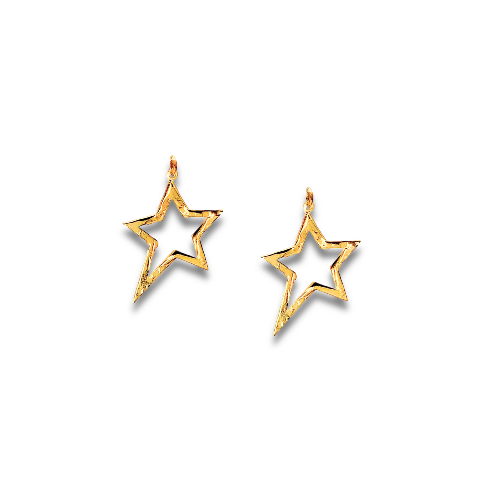 The image shows two Gold Shooting Star Dust Earring Charms by JAREDJAMIN Jewelry Online—gold, hollow, star-shaped with a hammered texture and small loops, ideal as 18K Gold Plated additions to your Hoop Earring Collection.