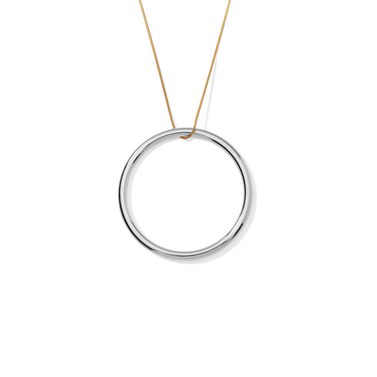 The Heavenly Hoop Round Pendant Necklace by JAREDJAMIN Jewelry Online features a sleek 18K gold-tone snake chain with a polished silver circular pendant. Its minimalist and sophisticated design creates an elegant, modern look.