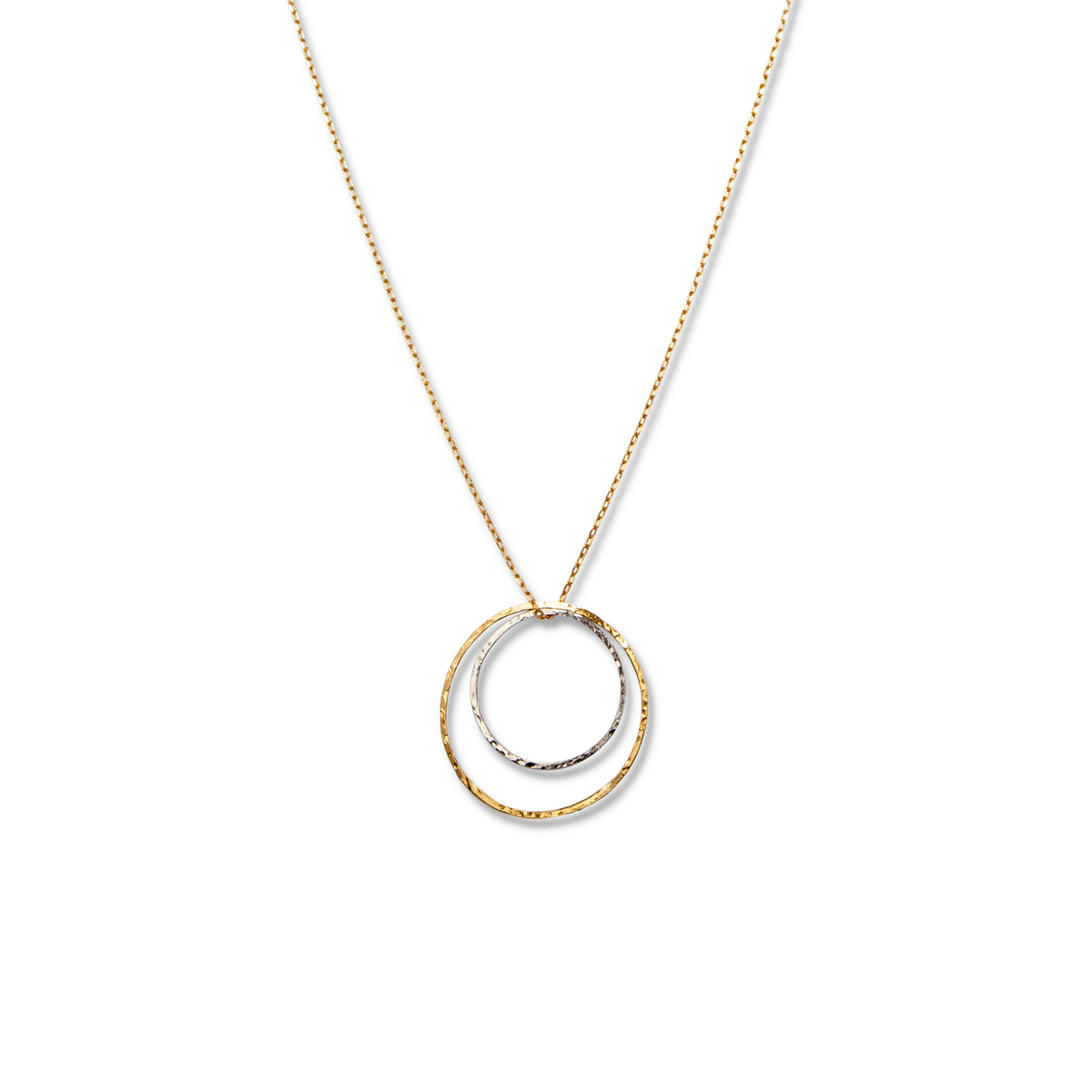 The Lindy Circles Pendant Chain Necklace from JAREDJAMIN Jewelry Online features two interlocking hammered rings—one gold, one silver—on an 18k gold-plated chain, displayed on a plain white background for a minimal and elegant look.