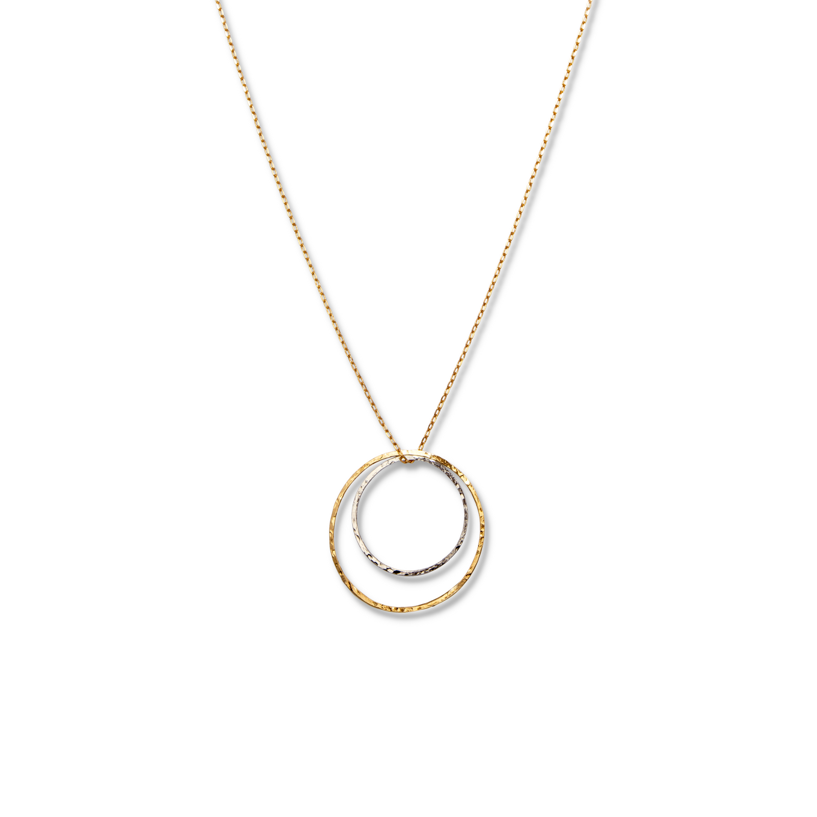 The Lindy Circles Pendant Chain Necklace from JAREDJAMIN Jewelry Online features two interlocking hammered rings—one gold, one silver—on an 18k gold-plated chain, displayed on a plain white background for a minimal and elegant look.