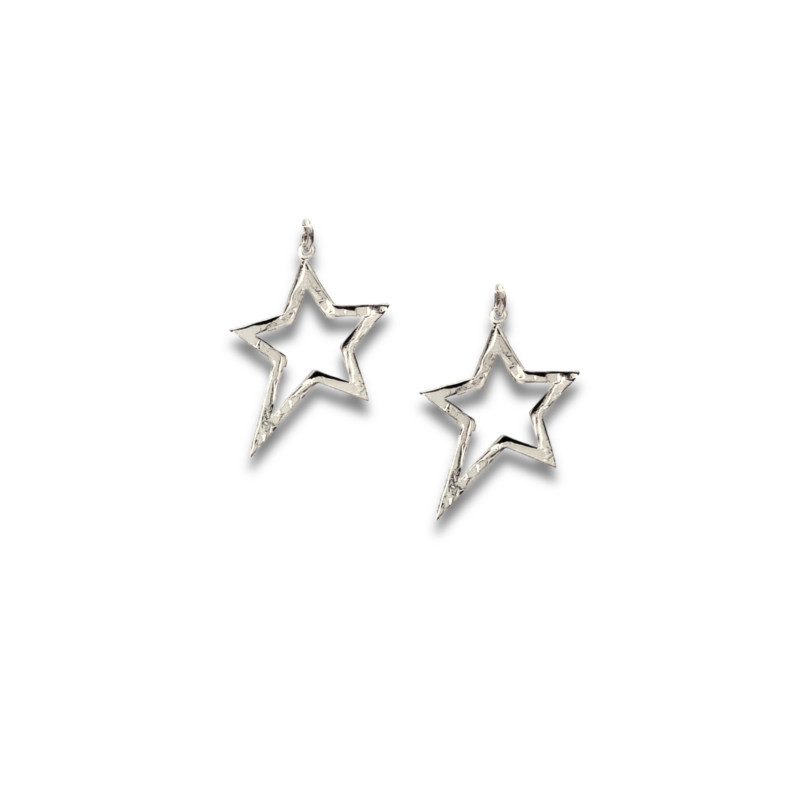 JAREDJAMIN Jewelry Online’s Silver Shooting Star Dust Earring Charms feature open-star shapes with textured edges, a silvery finish, and a minimalist design—each star tilting in opposite directions on a white background.