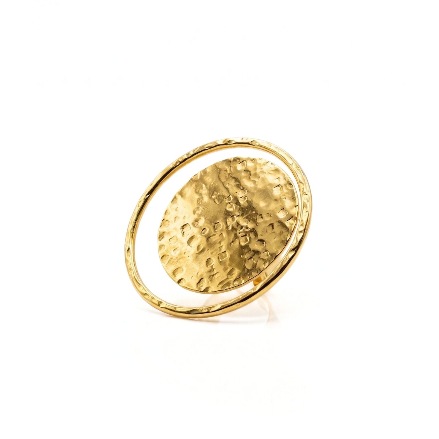The Large Peacock Eye Ring by JAREDJAMIN Jewelry Online features a hammered brass disc at the center, framed by a slim, smooth band. This adjustable gold ring shines against a plain white background with its eye-catching reflective finish.