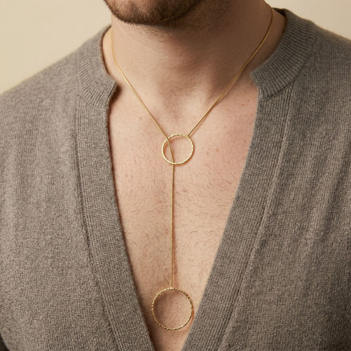 A taupe V-neck frames the Lindy Y-Necklace—an adjustable gold lariat with two hand-hammered discs, meticulously assembled in our West Hollywood studio. Ethically crafted in small batches. Style Note: punctuates denim or silk with quiet poise.
