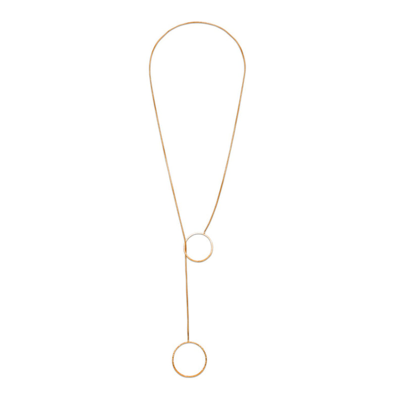 The Lindy Y-Necklace captures quiet geometry in a hand-assembled gold chain, punctuated by duo open circles. Sculpted in small batches at our West Hollywood studio with eco-minded precision. Style note: refracts from crisp shirting to silk after dark.