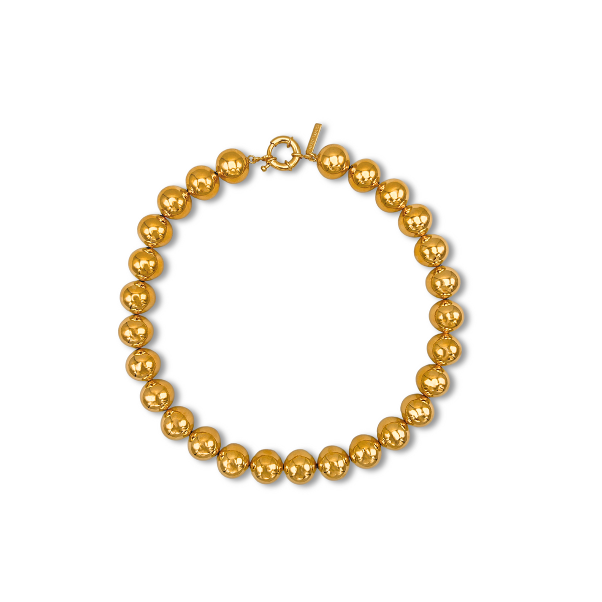 The Lucille Ball Necklace by JAREDJAMIN Jewelry Online is shown in a circle on a white background, featuring large, shiny, round hollow brass beads with a toggle clasp. The polished beads are evenly spaced and reflective.