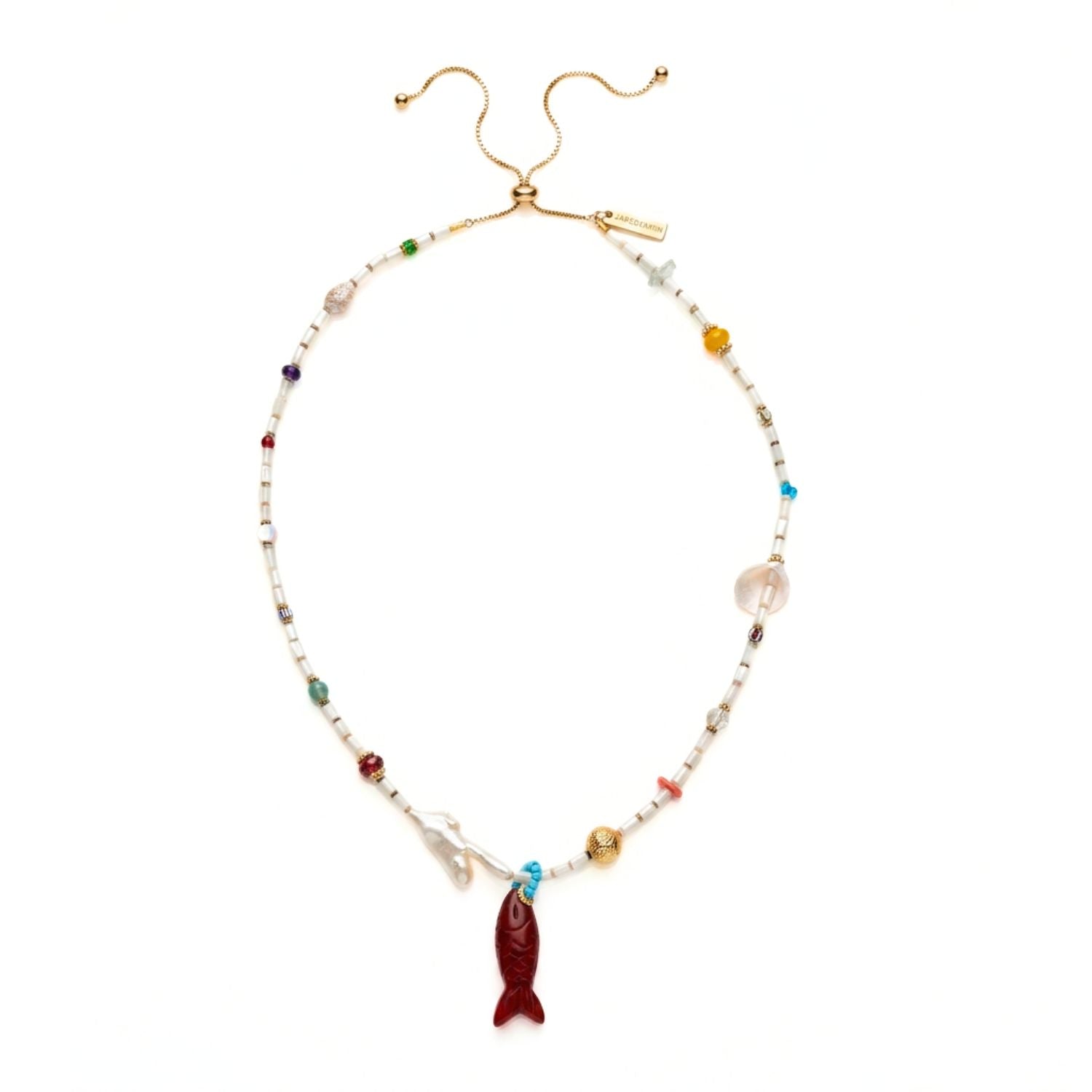 High-resolution studio product shot of the JAREDJAMIN Marisol Adjustable Necklace displayed in a loop on a white background, highlighting the mother-of-pearl beads, coral branch-shaped freshwater pearl, natural shells, sliding elevator clasp, and carved Red Jasper fish pendant.