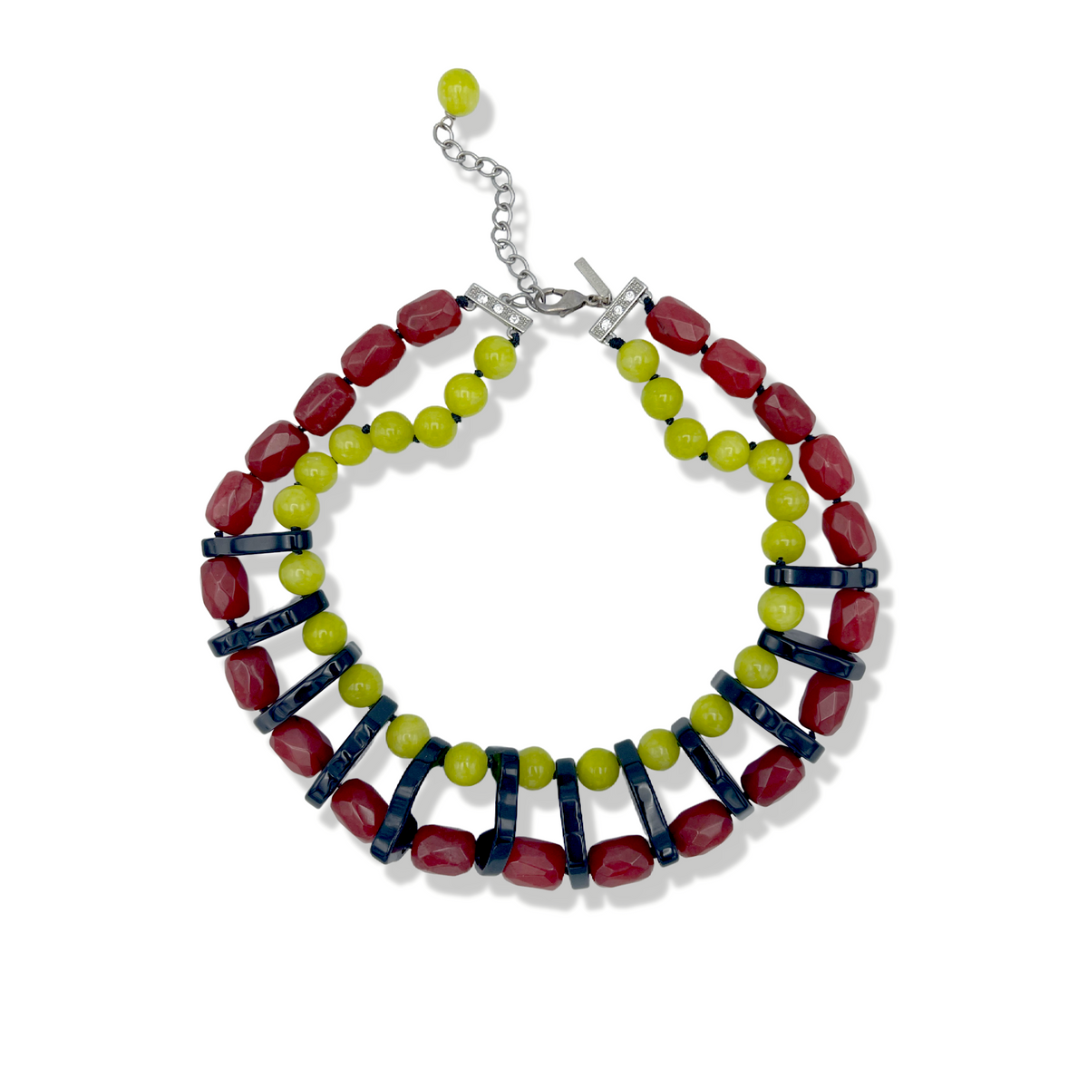 The Modern Mix Gemstone Necklace by JAREDJAMIN Jewelry Online features chunky two-strand styling with lime-green and red faceted beads, dark blue spacers, a sterling silver lobster clasp, and an adjustable chain finished with a green bead.