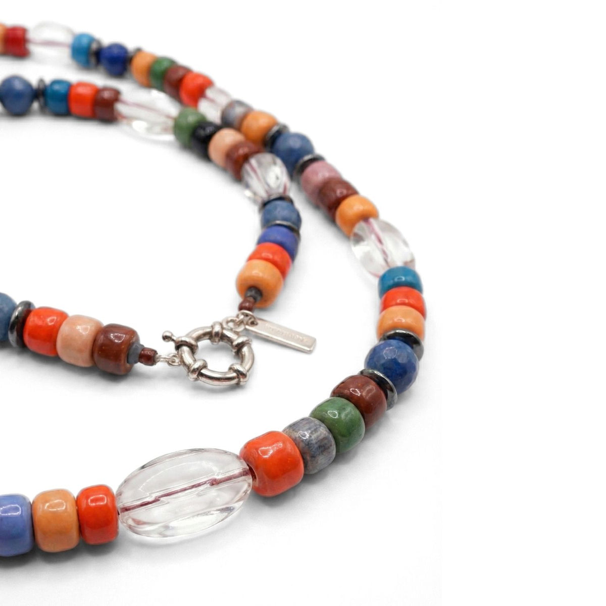 Nomad Beaded Quartz Necklace—meticulously hand-assembled in our West Hollywood studio—captures interplay of red, blue, orange, brown, green, and clear glass beads. Crafted in small eco-conscious batches with a signature tag. Style Note: punctuates denim or silk.