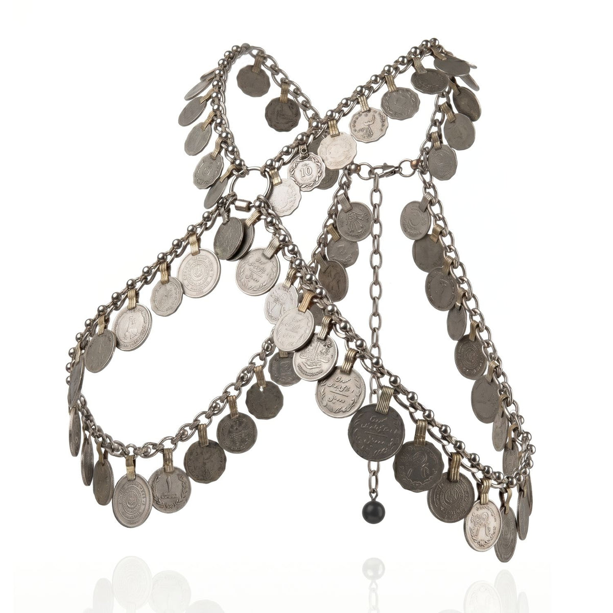 Hand-assembled in our West Hollywood studio, the Norbu Coin Harness weaves recycled silver chains and embossed coins into sculptural geometry. Limited-edition, eco-conscious. Style Note: punctuates crisp shirting or sculpts daring evening looks.