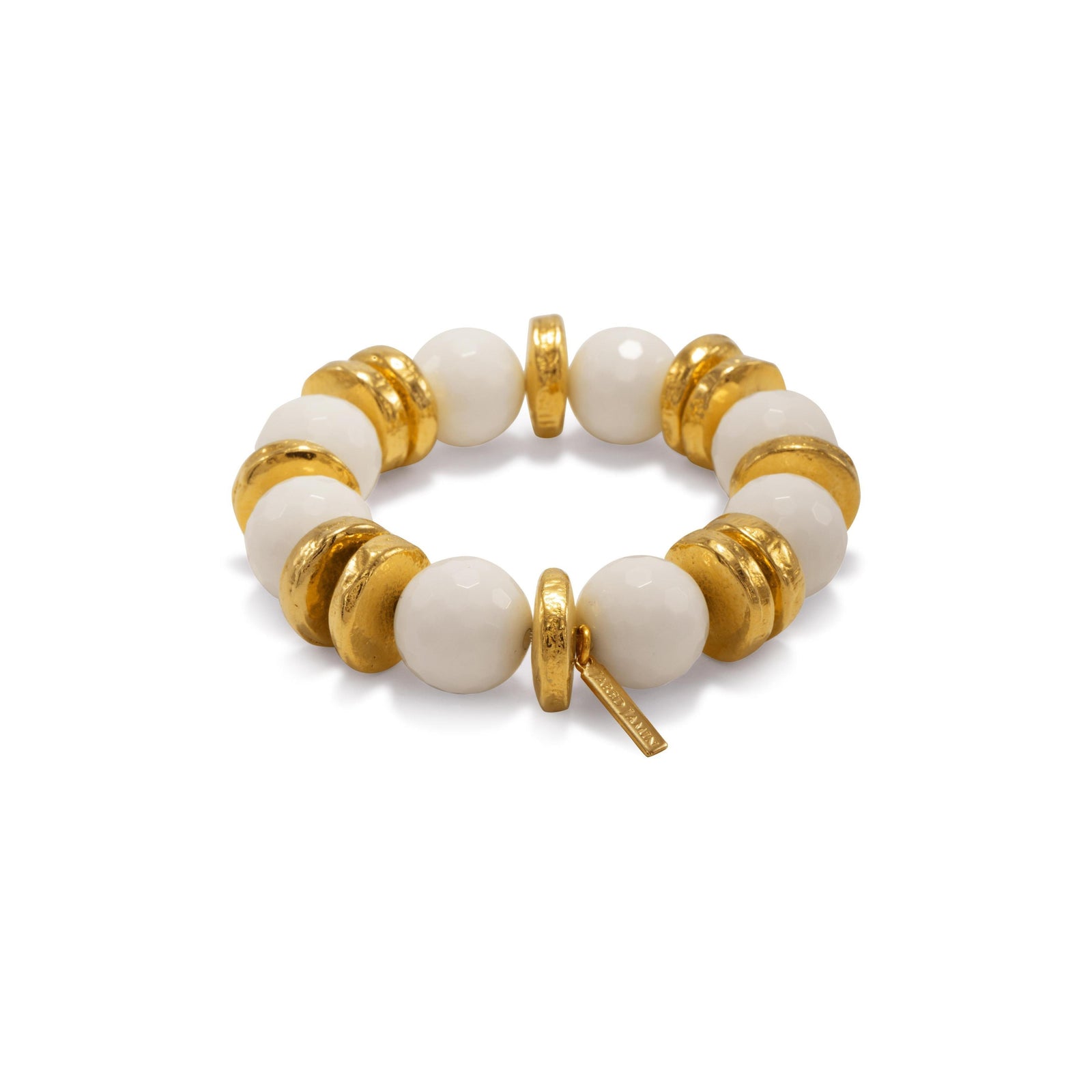 The Olivia White Stretch Bracelet by JAREDJAMIN Jewelry Online features alternating large white agate beads and flat 18K gold-plated discs with a rectangular gold tag, creating a stylish and elegant accessory.