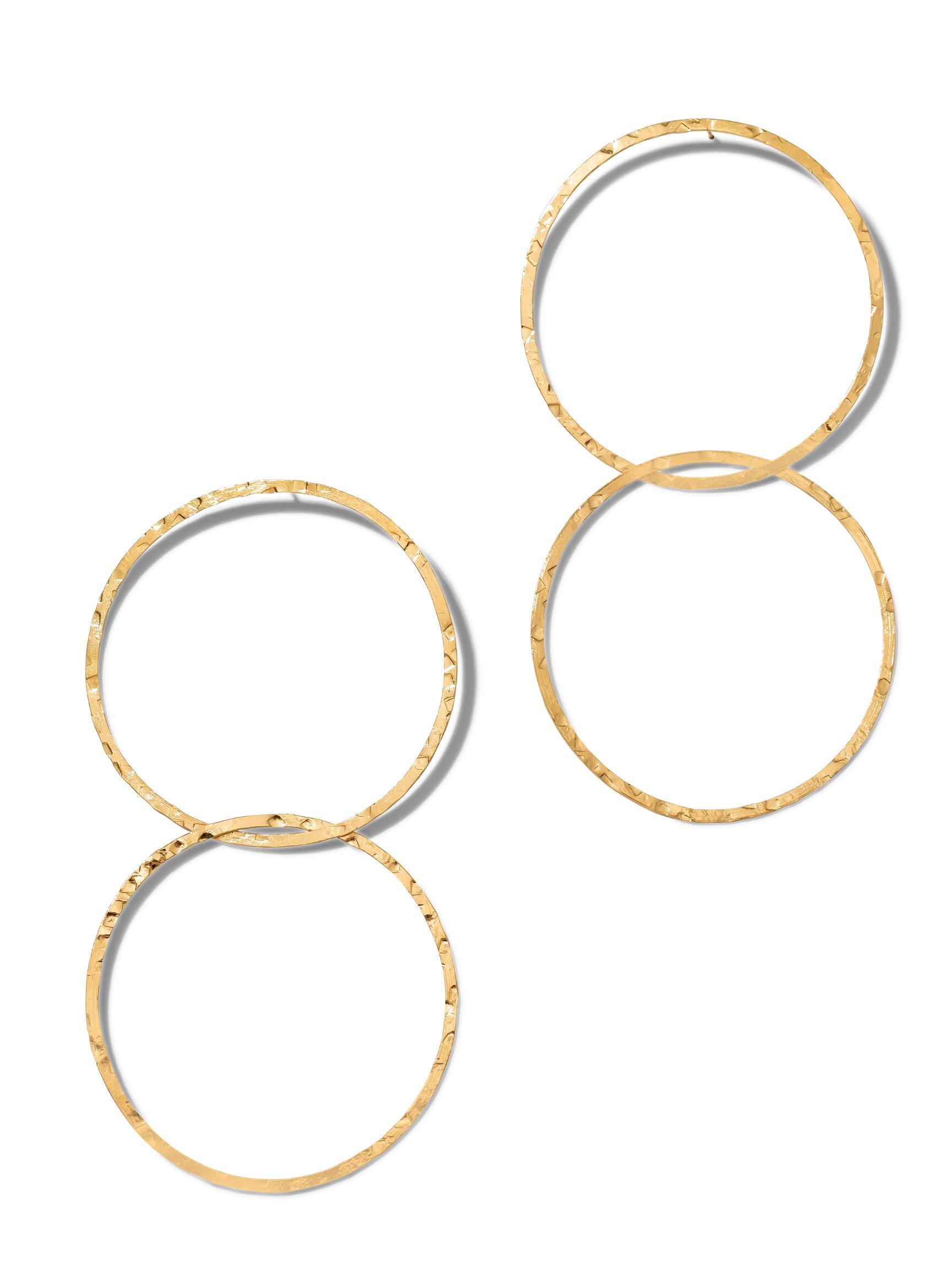 Two Gold Raquel Dangle Hoop Post Earrings from JAREDJAMIN Jewelry Online, part of the Halo Lindy Collection, are arranged vertically. Each pair features interlinked 18K gold-plated hoops with a textured, hammered finish for a rustic yet modern and stylish allure.