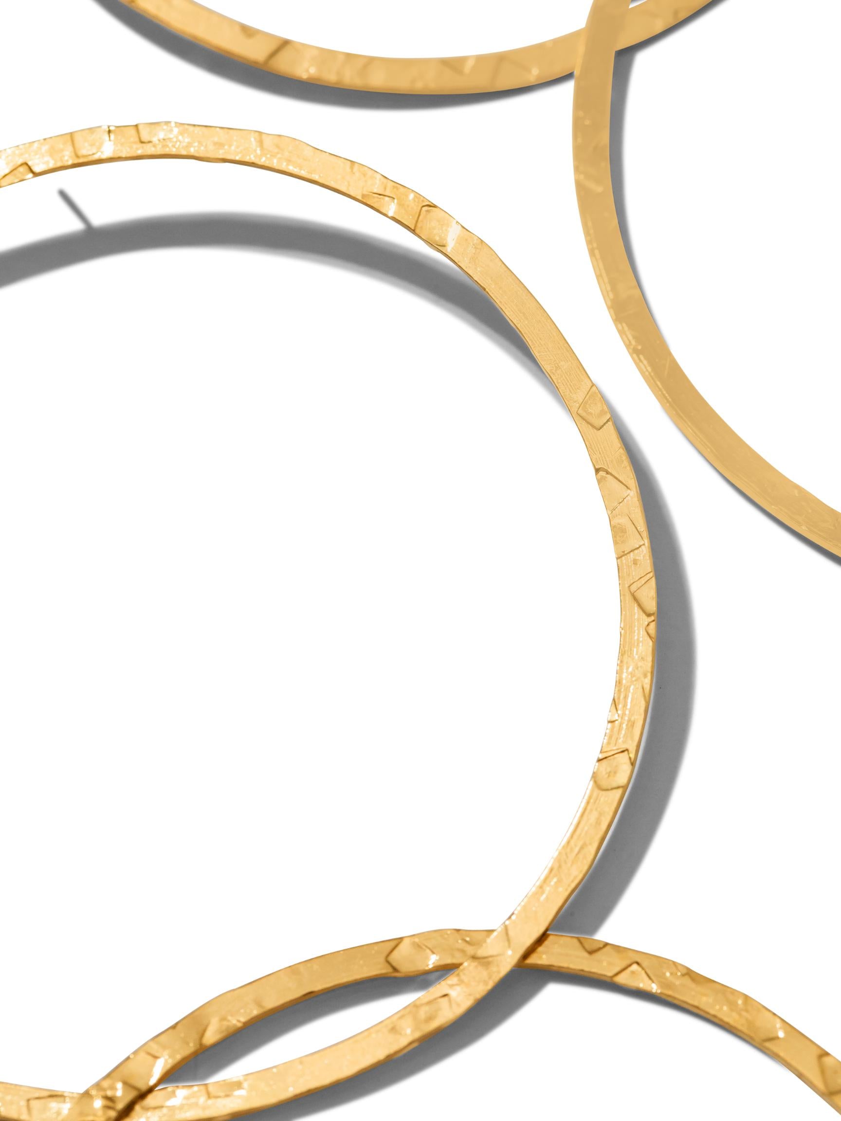 Two Gold Raquel Dangle Hoop Post Earrings from JAREDJAMIN Jewelry Online, part of the Halo Lindy Collection, are arranged vertically. Each pair features interlinked 18K gold-plated hoops with a textured, hammered finish for a rustic yet modern and stylish allure.