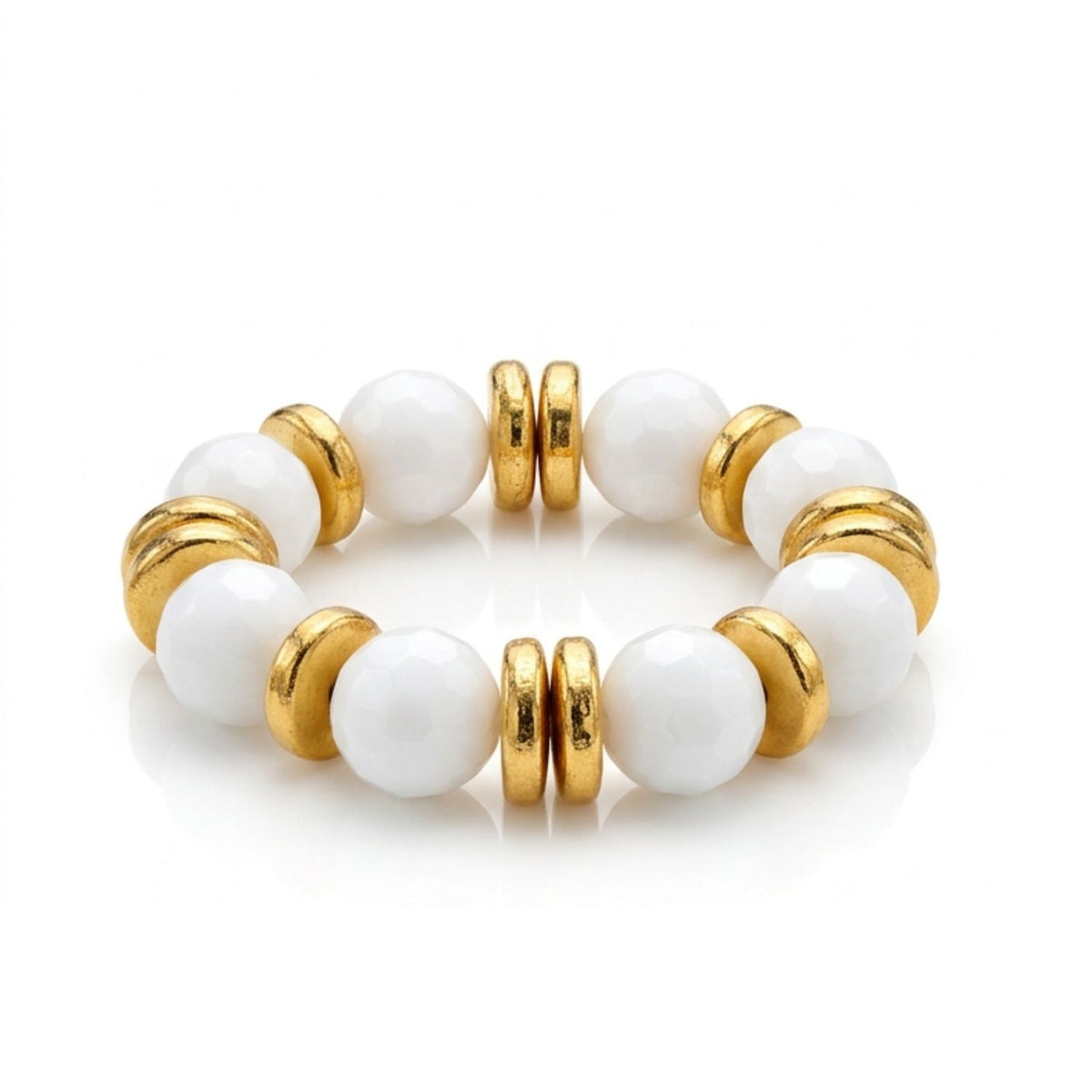 Studio product shot of the JAREDJAMIN Olivia gemstone bracelet variant showcasing the 16mm faceted white stone spheres contrasted against thick, high-shine 18k gold-plated rondelle spacers on a reflective surface.