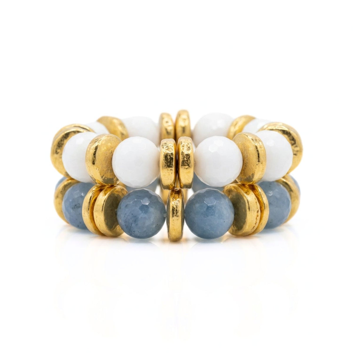 Stack of beaded rings with gold, white, and blue beads on a white background