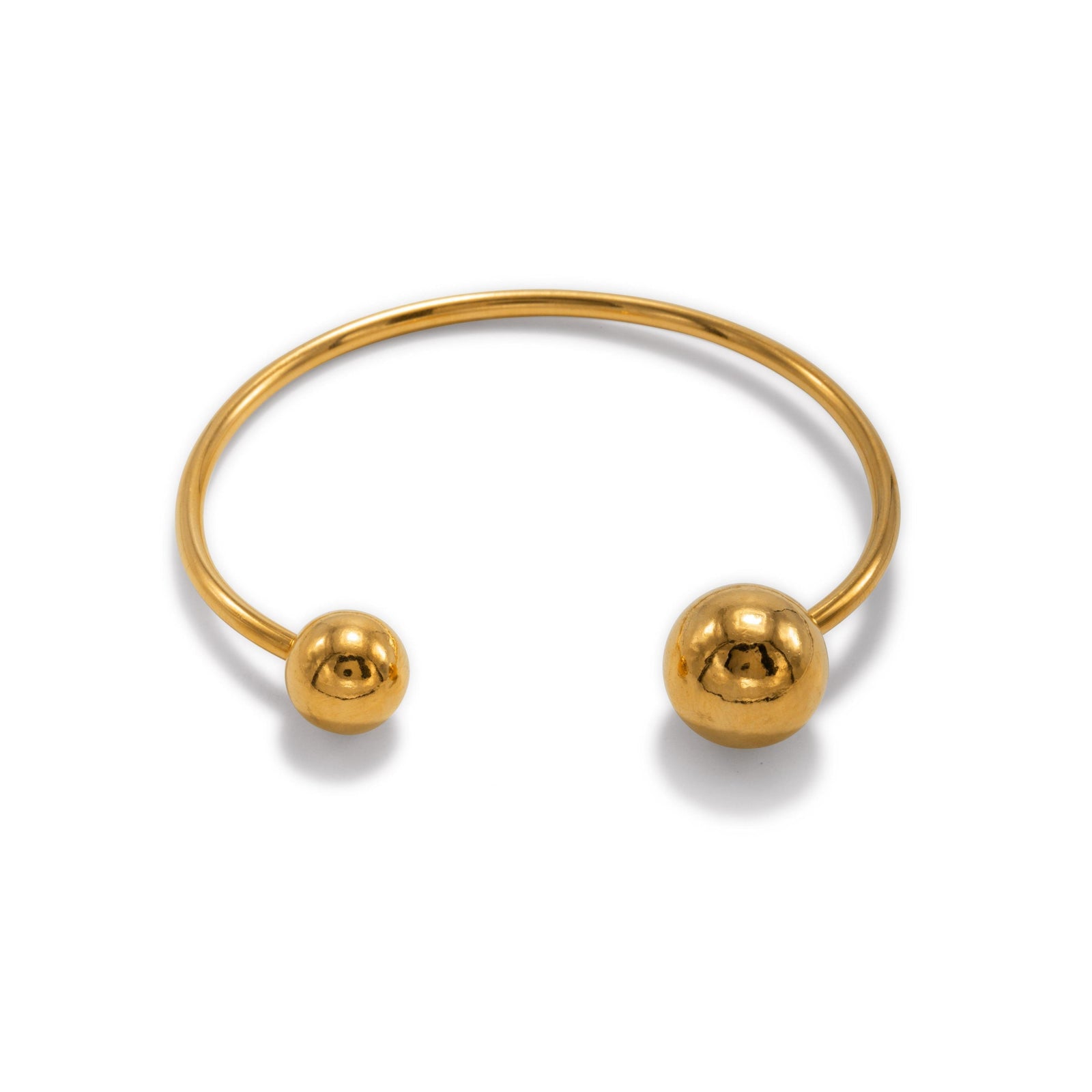 The Gold Orbita Bracelet by JAREDJAMIN Jewelry Online is an 18K gold-plated piece with a polished finish, featuring two textured orbs—one large and one small—at each open end.