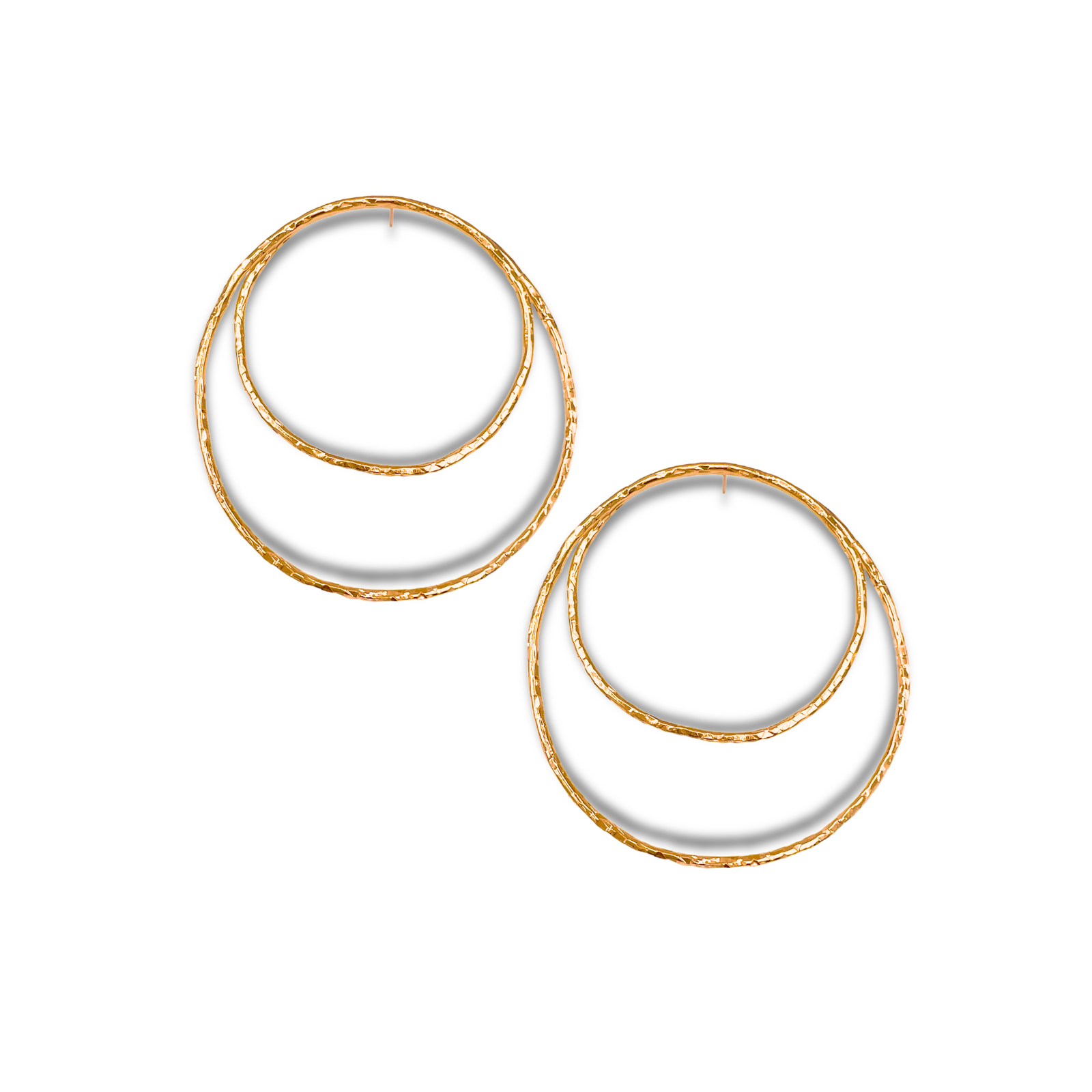 Two pairs of Ottavia Gold Post Earrings by JAREDJAMIN Jewelry Online, featuring large 18K gold plating and textured hammered surfaces, overlap on a white background. Deep shadows highlight their luxury appeal.