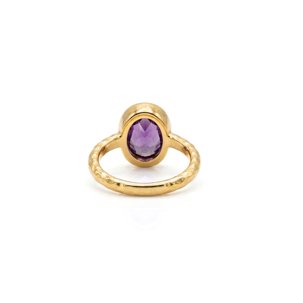 The JAREDJAMIN Jewelry Online Oval Amethyst Gemstone Ring features an 18K gold-plated textured band and a bezel-set, oval-cut amethyst, shown upright on a white background to highlight its rich color and faceted surface.