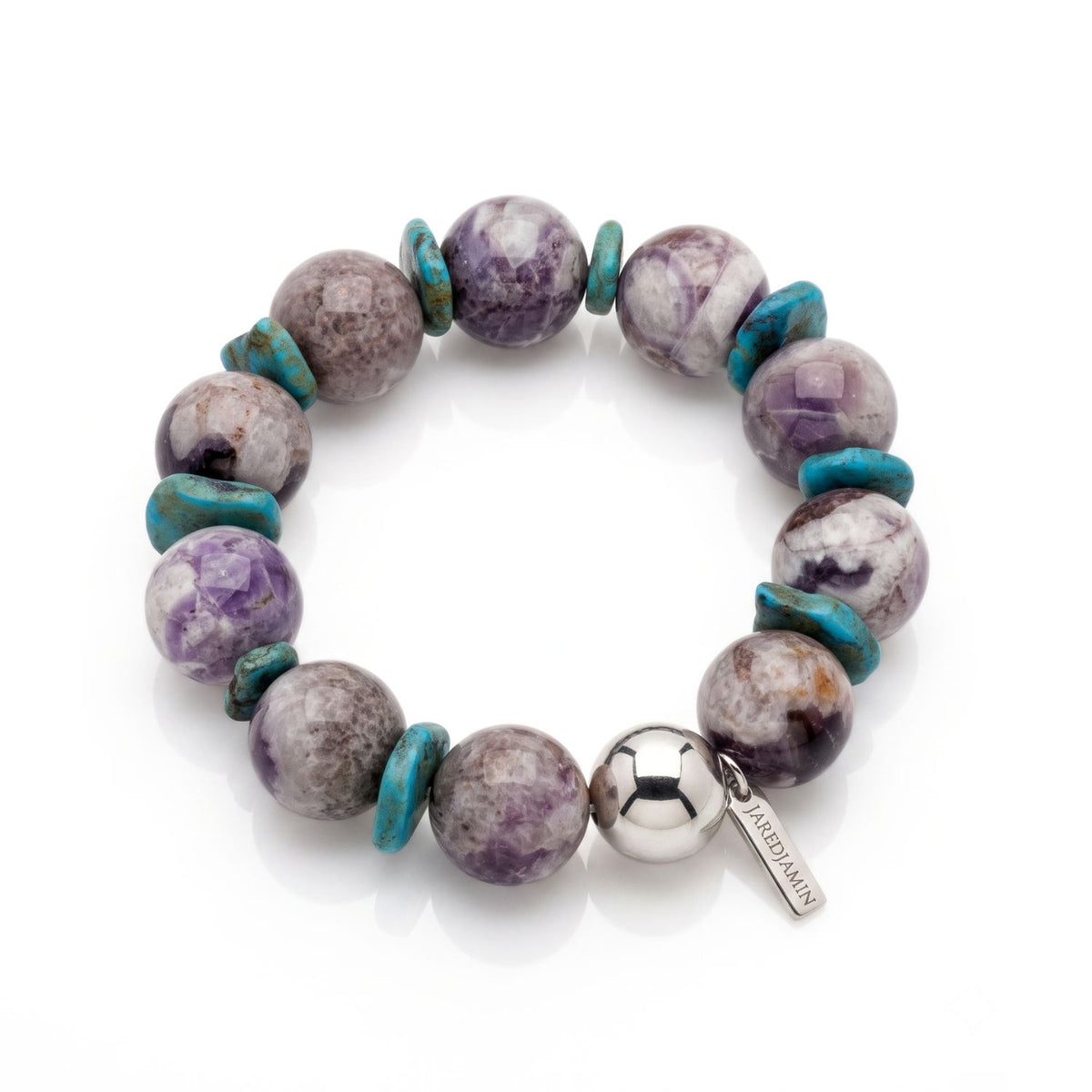 High-resolution studio product shot of the JAREDJAMIN Paloma Amethyst & Turquoise Howlite Stretch Bracelet displayed flat against a white background, showing the 16mm amethyst beads, turquoise howlite disc spacers, 14mm silver sphere, and logo tag.