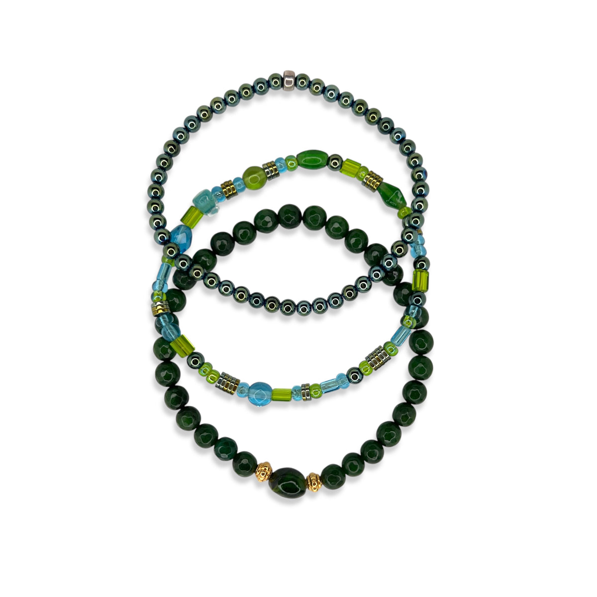 The Emerald City Bracelet Set by JAREDJAMIN Jewelry Online features three stacked bracelets with blue and green tones, including aventurine, abalone shell, mixed blue beads, glossy dark green beads, and gold-toned hematite accents.