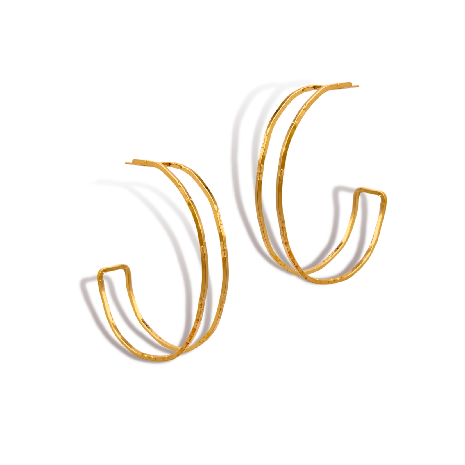 The Ravello Hoop Post Earrings by JAREDJAMIN Jewelry Online feature an open, double-band design in 18K gold plate, with two parallel, slightly irregular bands—ideal for bold accessorizing. The earrings are photographed casting soft shadows on a white background.