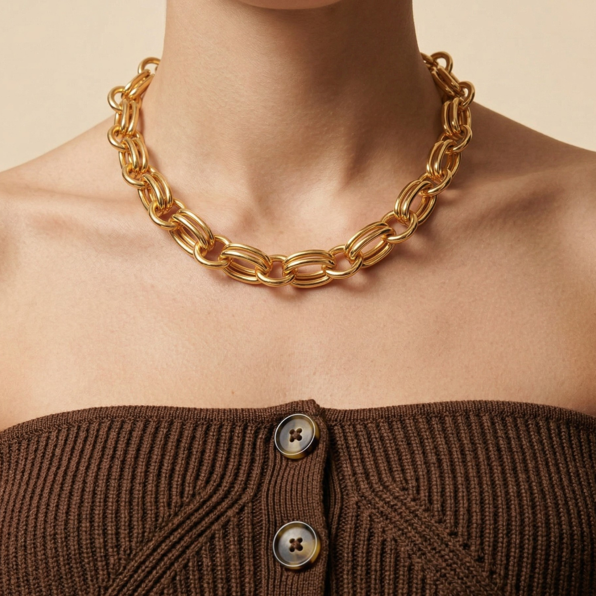 The Regent Chain Necklace, meticulously hand-assembled in our West Hollywood studio from small-batch, eco-conscious materials, punctuates a ribbed brown off-shoulder top. Style Note: effortlessly refines knits or crisp tailoring alike.