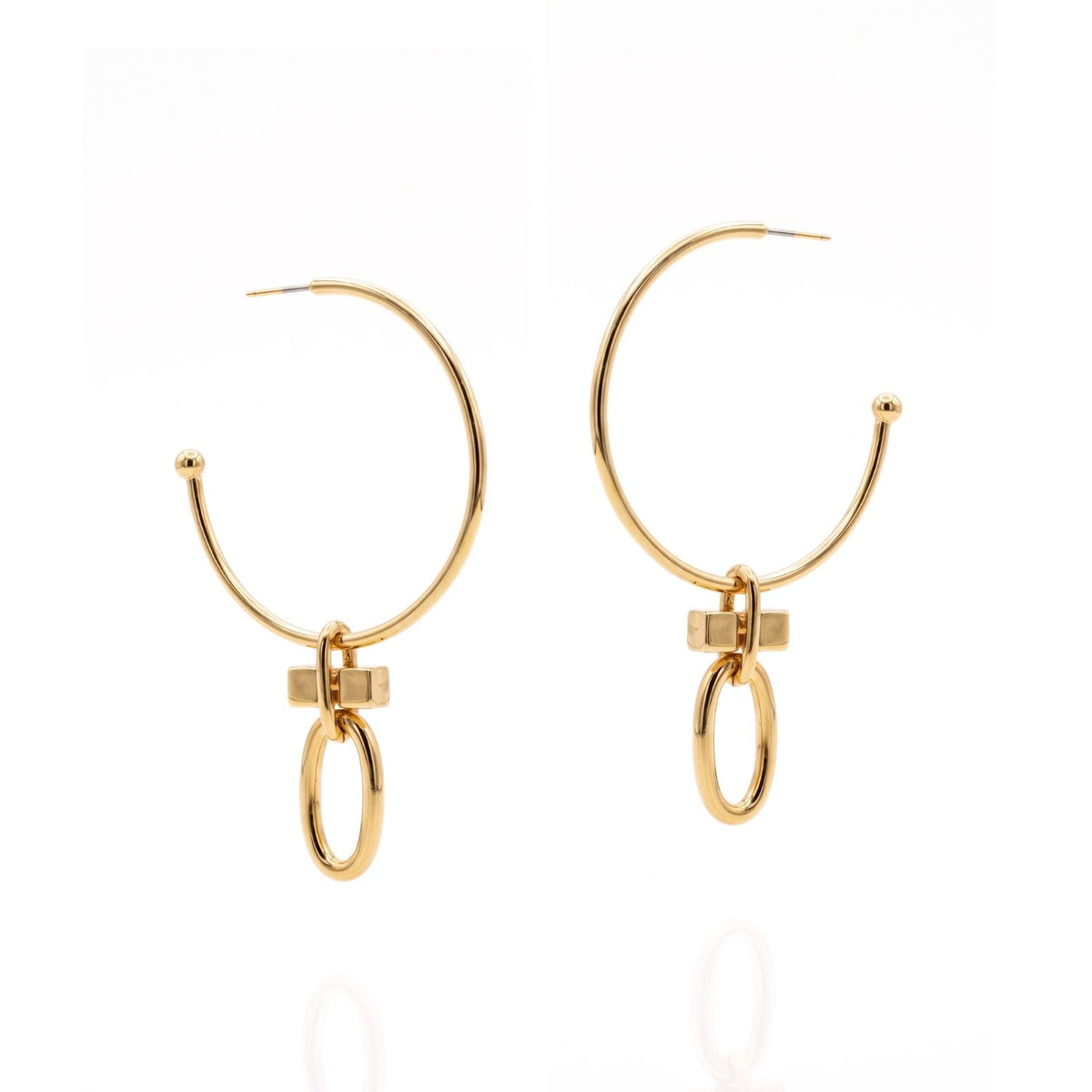 Flat lay of the JAREDJAMIN Gold Reign Hoop Earrings on a seamless white background, featuring the 2-inch smooth gold-plated brass hoops fully assembled with the geometric T-bar charms attached.