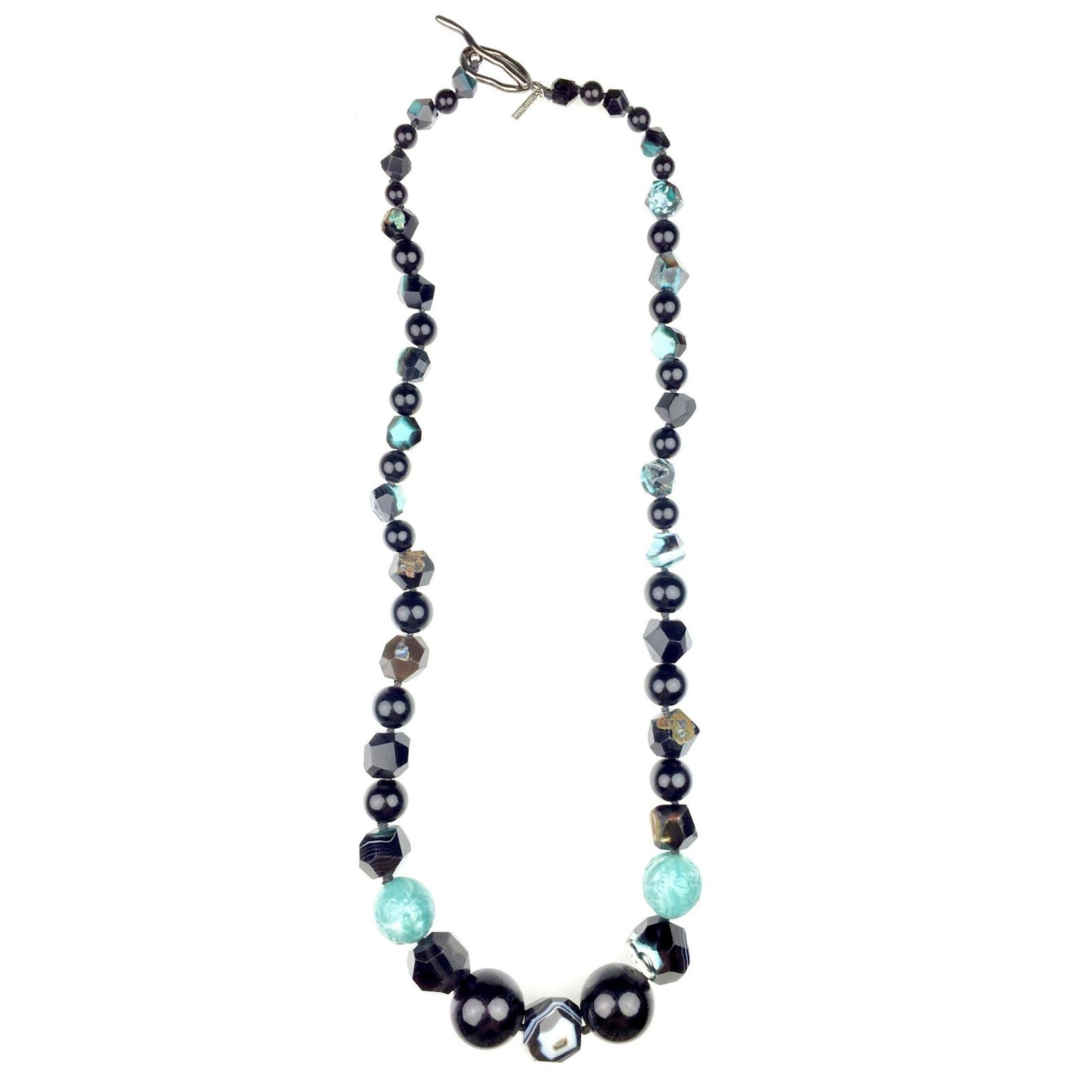 The Rock Of Gibraltar Necklace by JAREDJAMIN Jewelry Online features vintage resin beads and dyed faceted agate in black, turquoise, and metallic tones, arranged symmetrically with a silver toggle clasp, displayed oval-shaped on a white background.