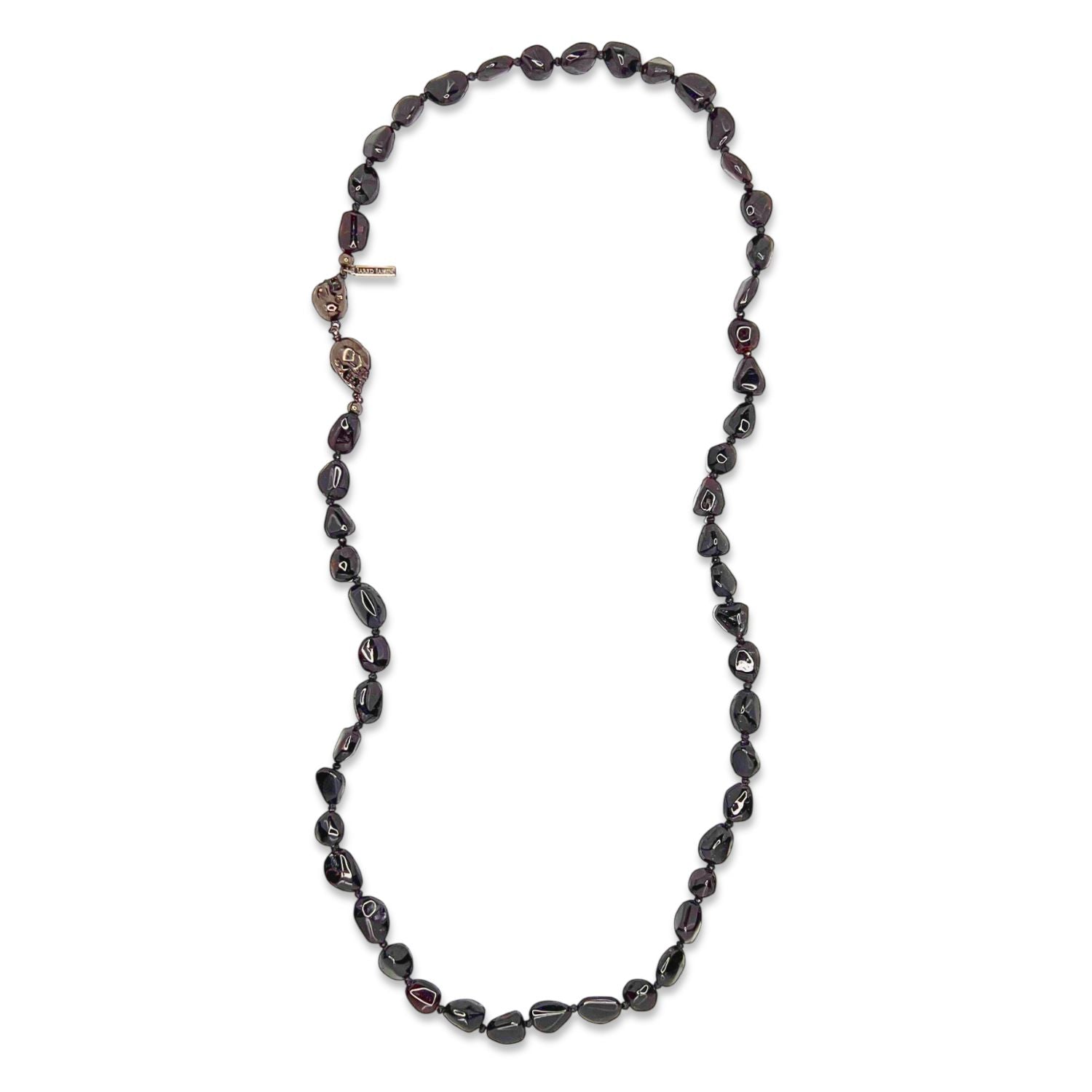 The Rocks of Sangria Skull-Clasp Necklace by JAREDJAMIN Jewelry Online features glossy, irregular garnet beads and a striking double-skull clasp on the left, creating an organic look against a plain white background.