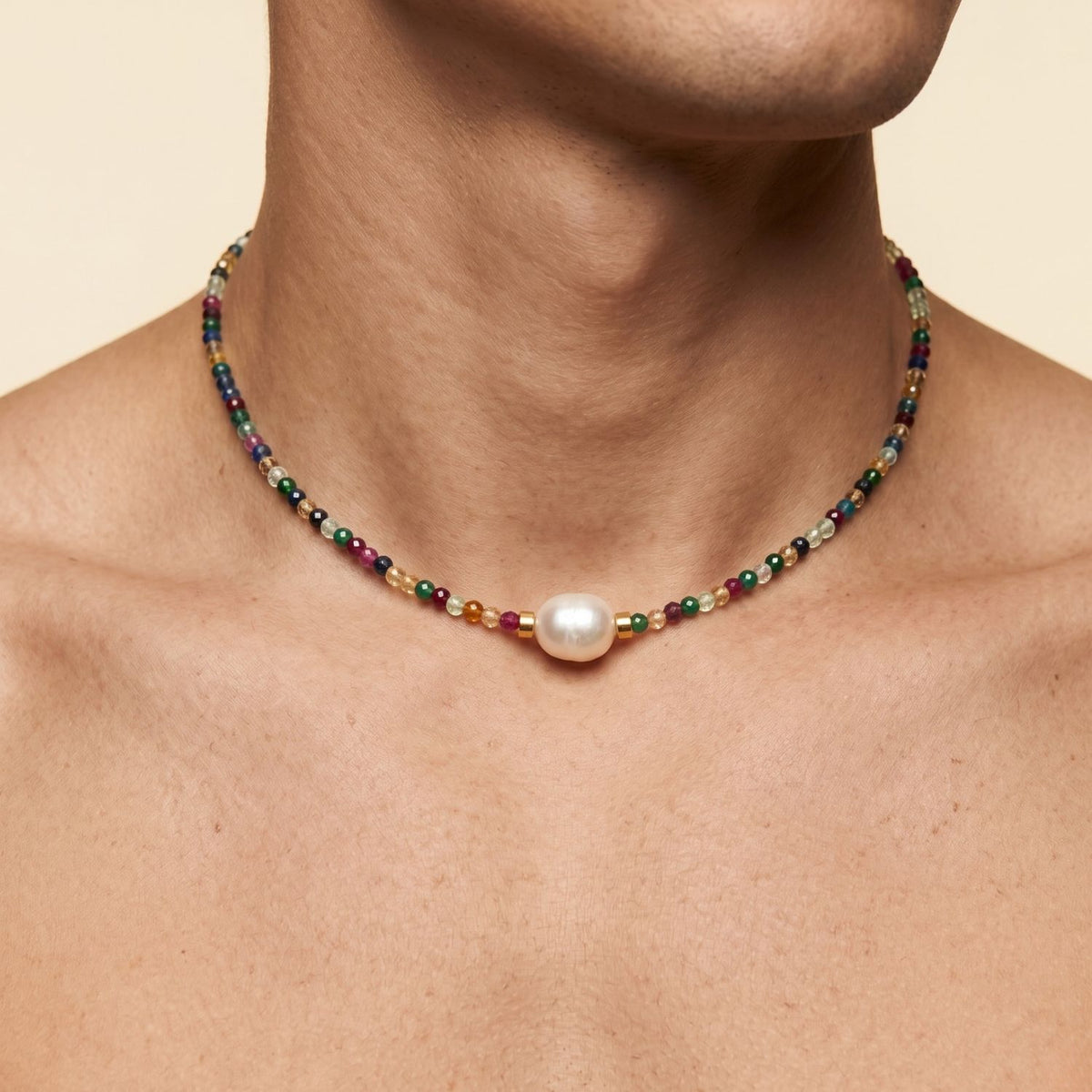 A close-up of a male model wearing the short Rowan Multi-Color Necklace, showcasing how the eclectic beads sit flat along the collarbone.