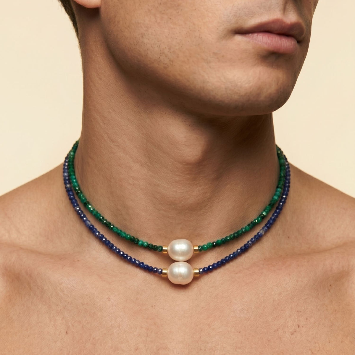 A model wearing a stacked look featuring the Rowan Lapis Lazuli Necklace layered directly beneath the companion green Rowan Malachite strand.